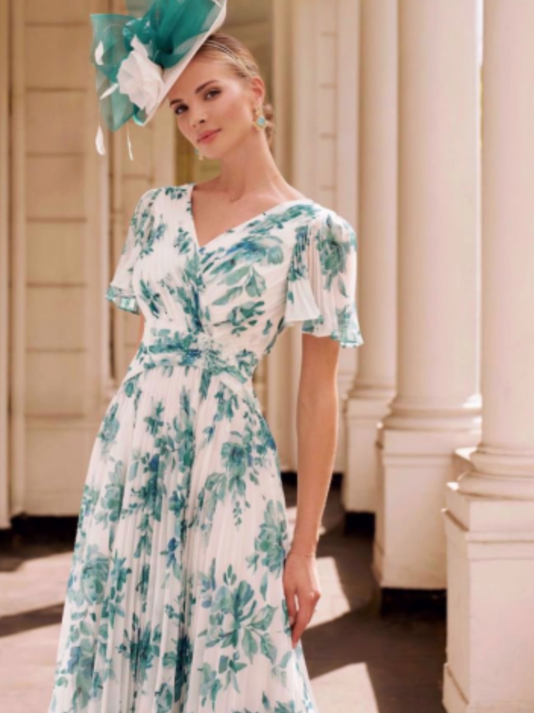 John Charles 66608B Pink Blossom Dress with V-neckline, flutter sleeves and a flowing pleated midi skirt — a romantic floral occasion dress perfect for weddings and elegant summer events.