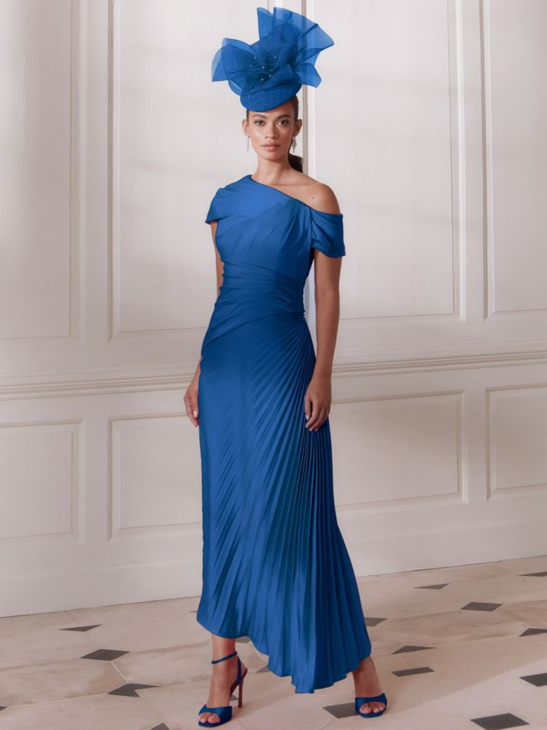 John Charles 66731 Peacock Dress with asymmetric neckline, pleated waistband and plissé midi skirt.