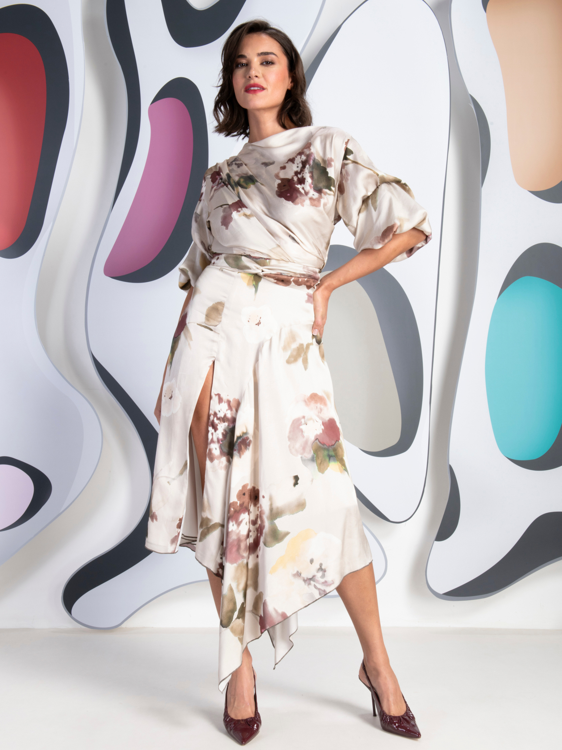 Kevan Jon Mila champagne sleeve split knee dress in pansy print with draped bodice and front split.