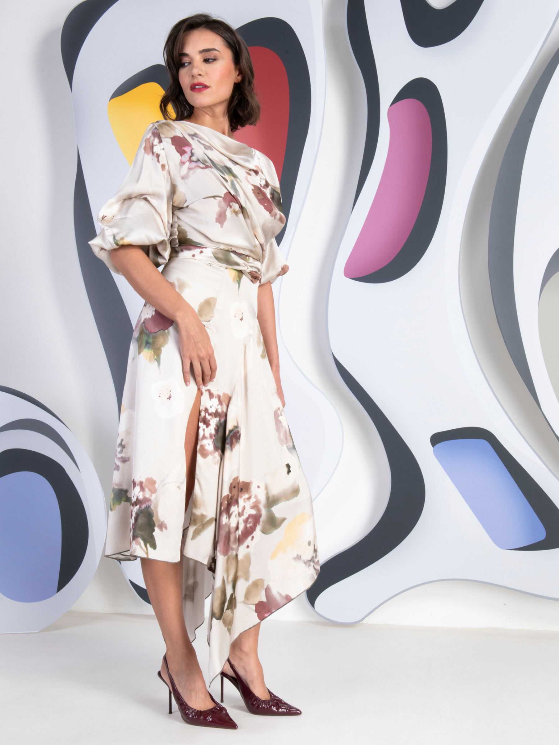 Kevan Jon Mila champagne sleeve split knee dress in pansy print with draped bodice and front split.