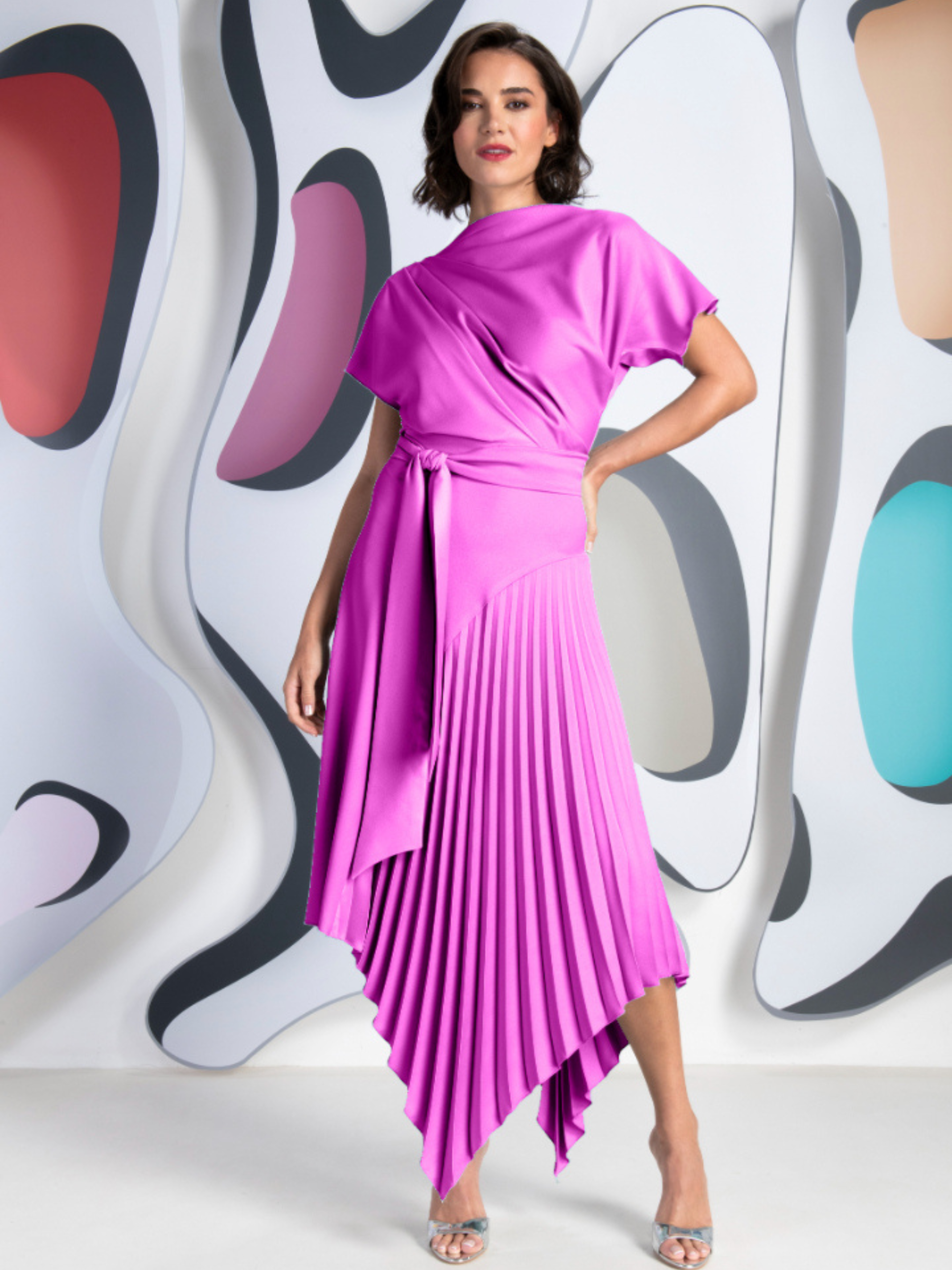 Kevan Jon Mila Pleat Fuchsia Knee Dress in satin crepe with draped bodice, tie waist and asymmetric pleated skirt.