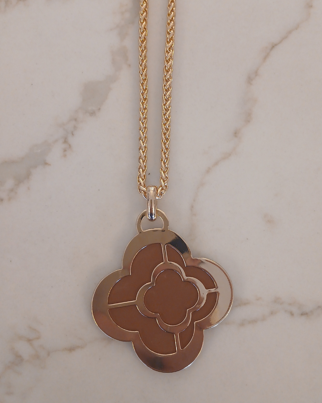 Gold necklace with a clover-shaped pendant
