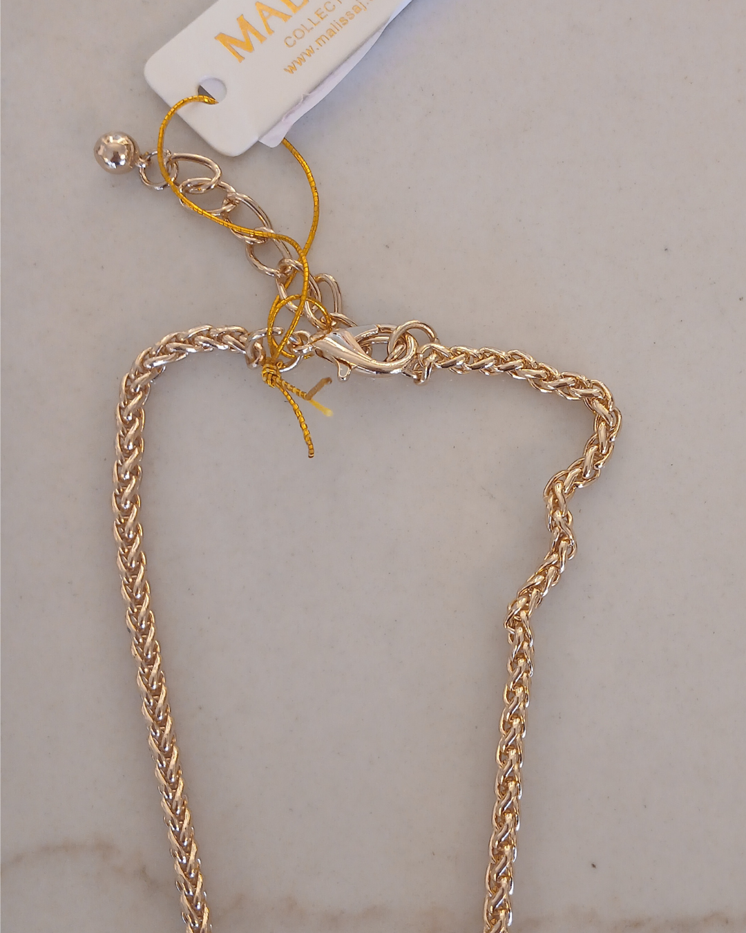 Gold necklace with a clover-shaped pendant