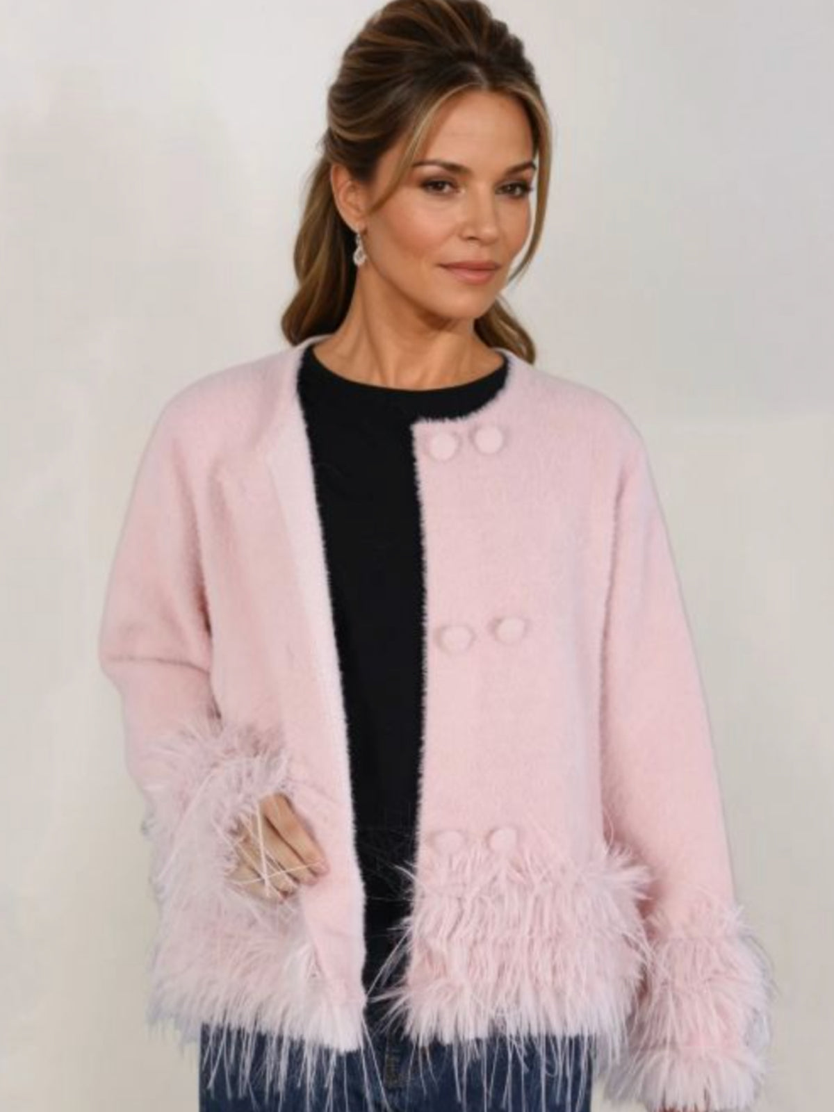 PCHA CA196 Feather Trim Cardigan with round neckline, button front and statement feather trim at the cuffs and hem.