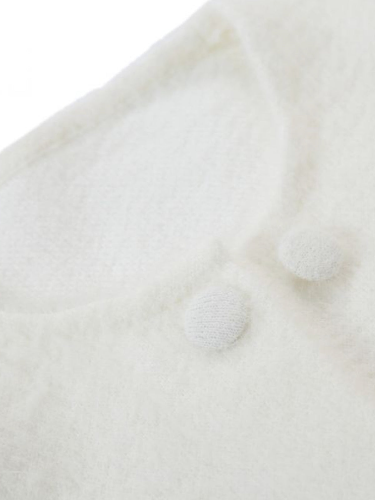 PCHA CA196 Feather Trim Cardigan with round neckline, button front and statement feather trim at the cuffs and hem.