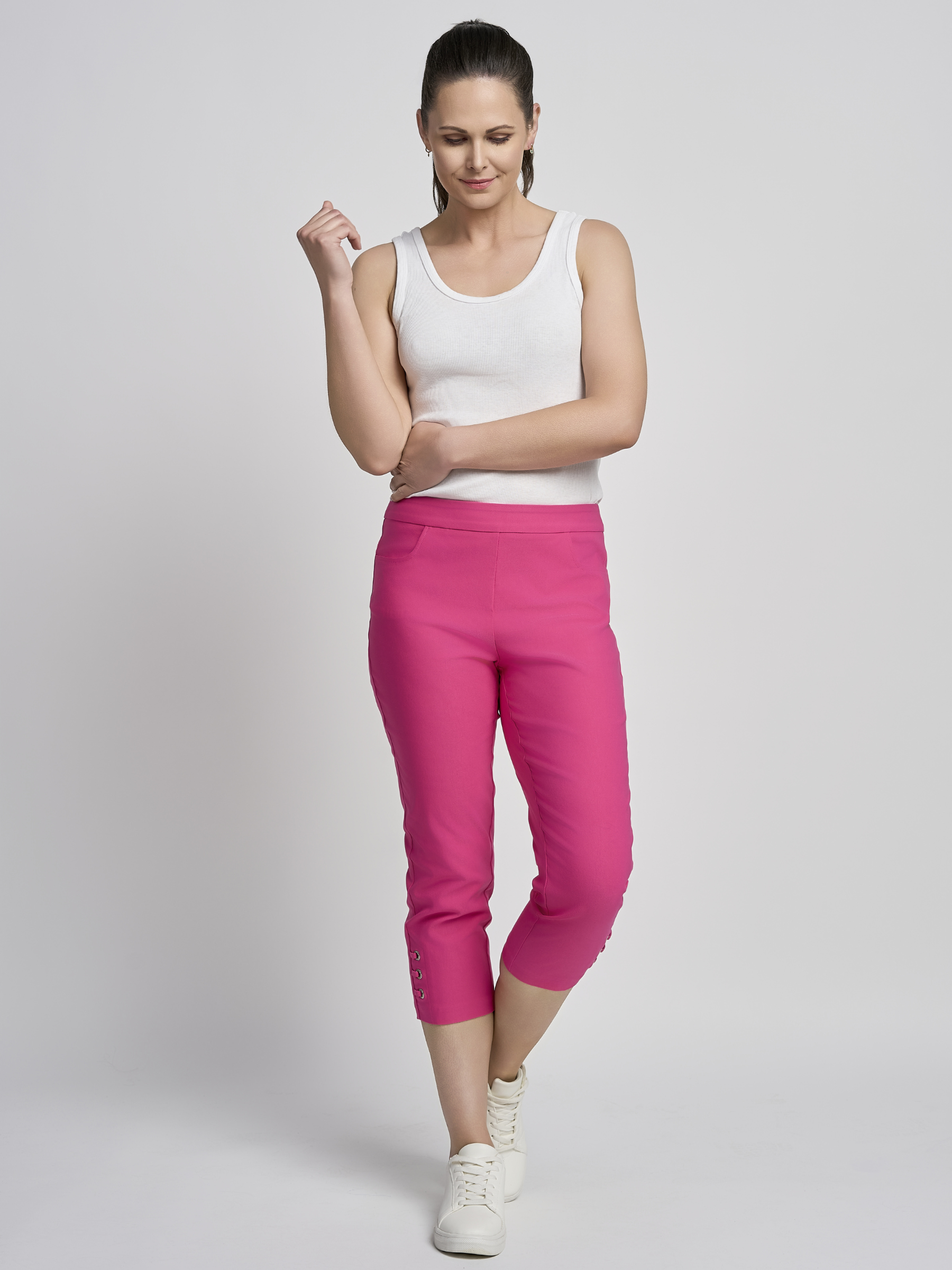 PINNS 408C fuchsia women’s sculpting bengaline crop trousers with hidden tummy control and diamond eyelet hem.