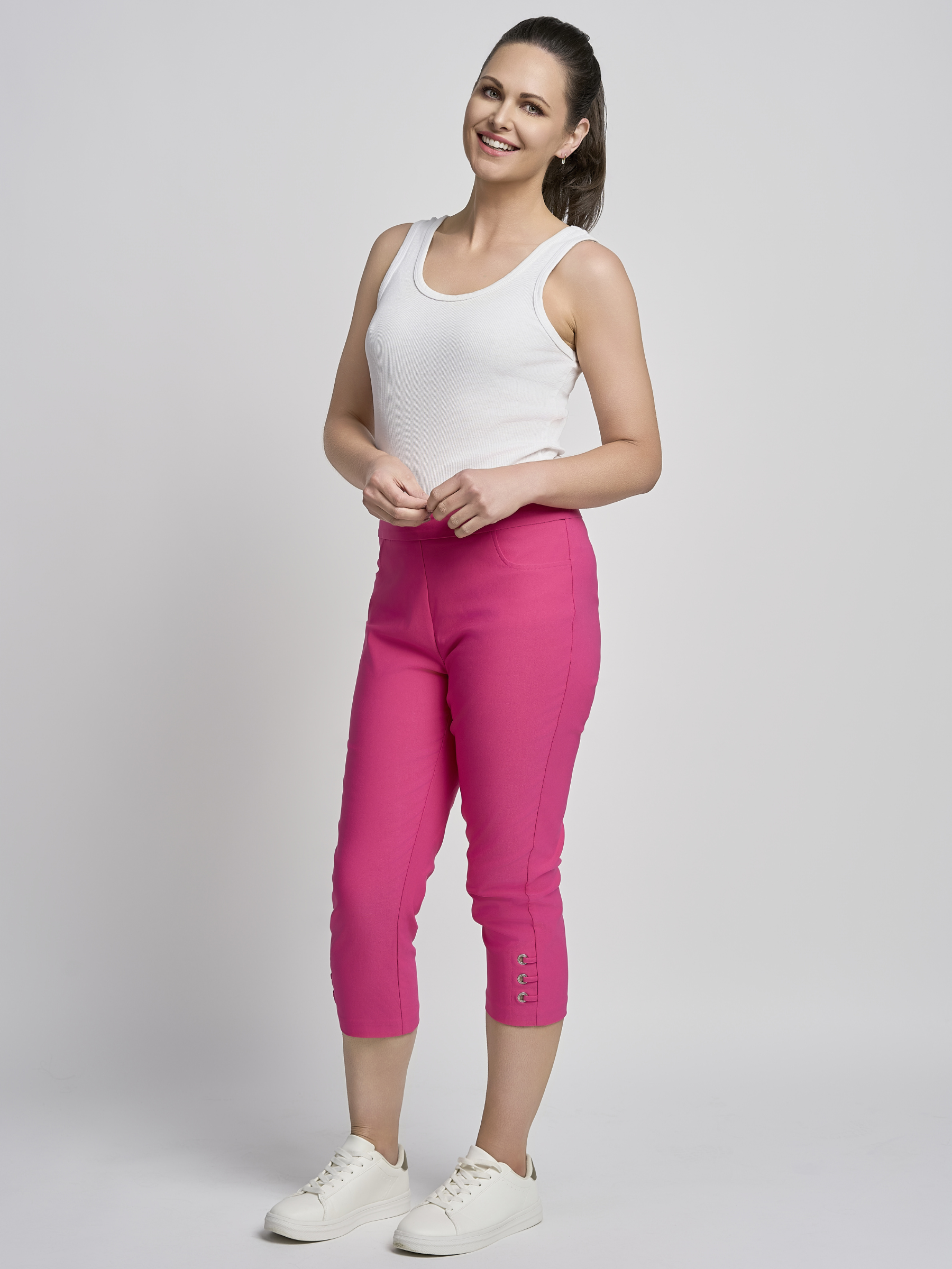 PINNS 408C fuchsia women’s sculpting bengaline crop trousers with hidden tummy control and diamond eyelet hem.