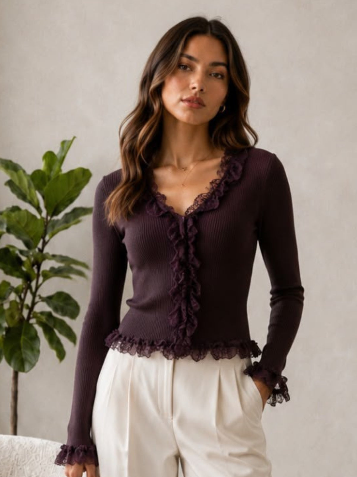 QBAW26 LX Lexy Top with V-neckline, long sleeves and lace ruffle detailing through the front, cuffs and hem.