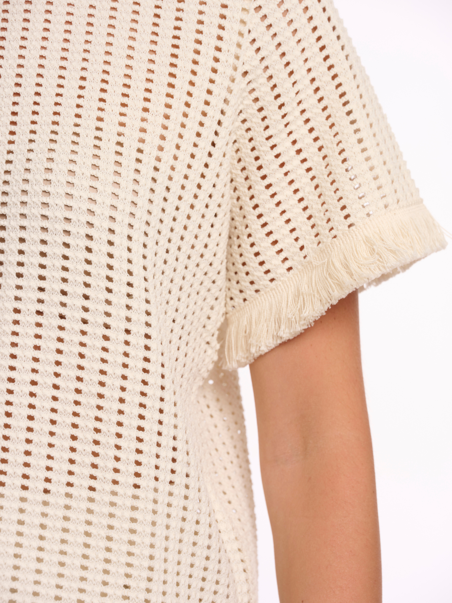 Rino & Pelle Flora Top open knit short sleeve top with fringe trim and round neckline.
