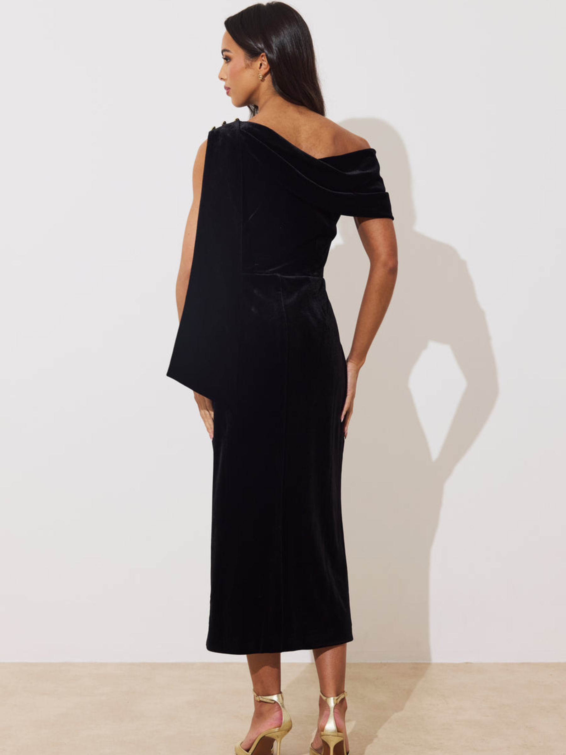 The 8th Sign Eleni Velvet Drape Midi Dress with asymmetric draped neckline, embellished shoulder detail and flowing back drape.