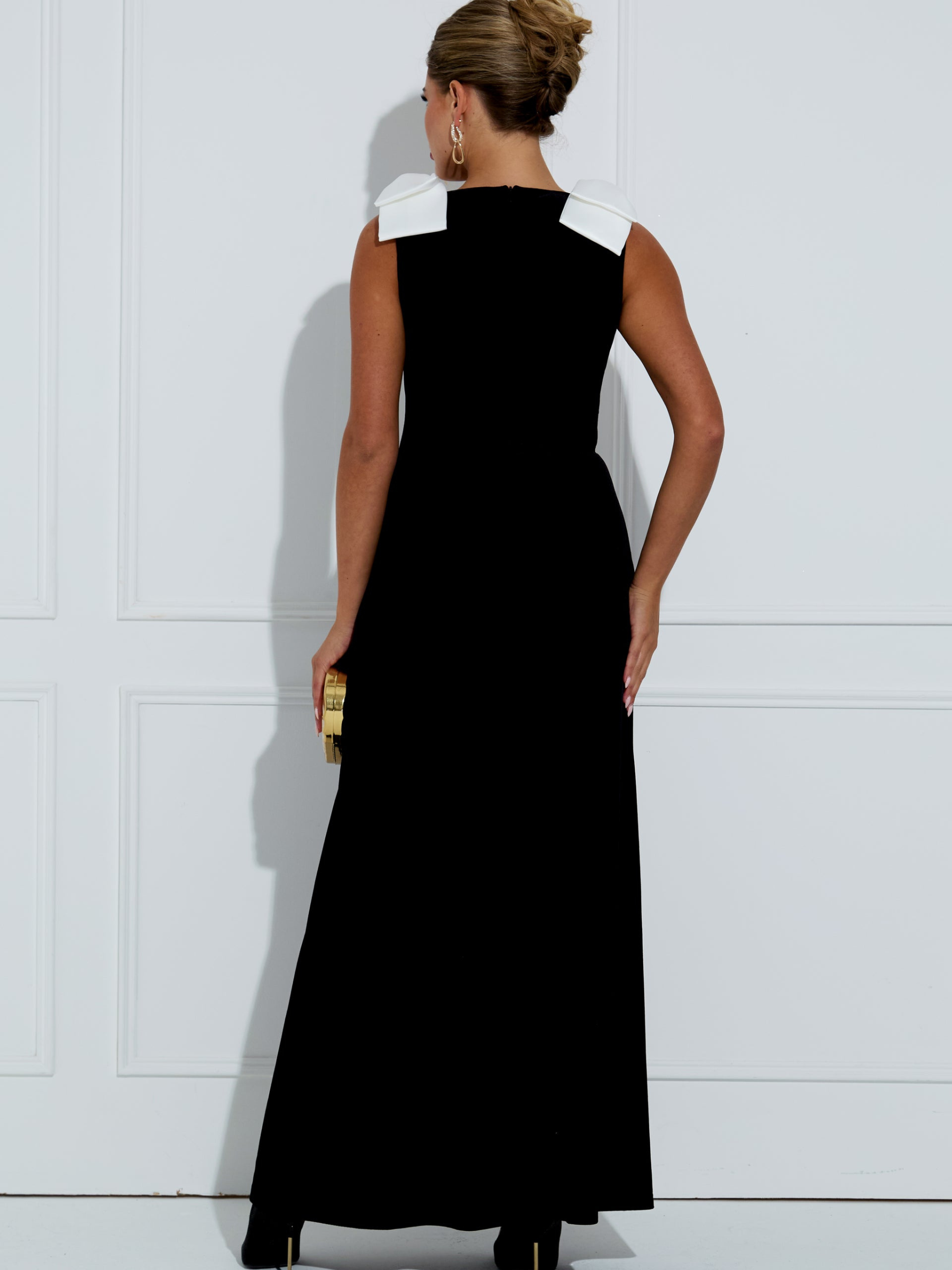 The 8th Sign Joan Velvet Bow Maxi Dress with V-neckline, shoulder bow detail, decorative buttons and front split.