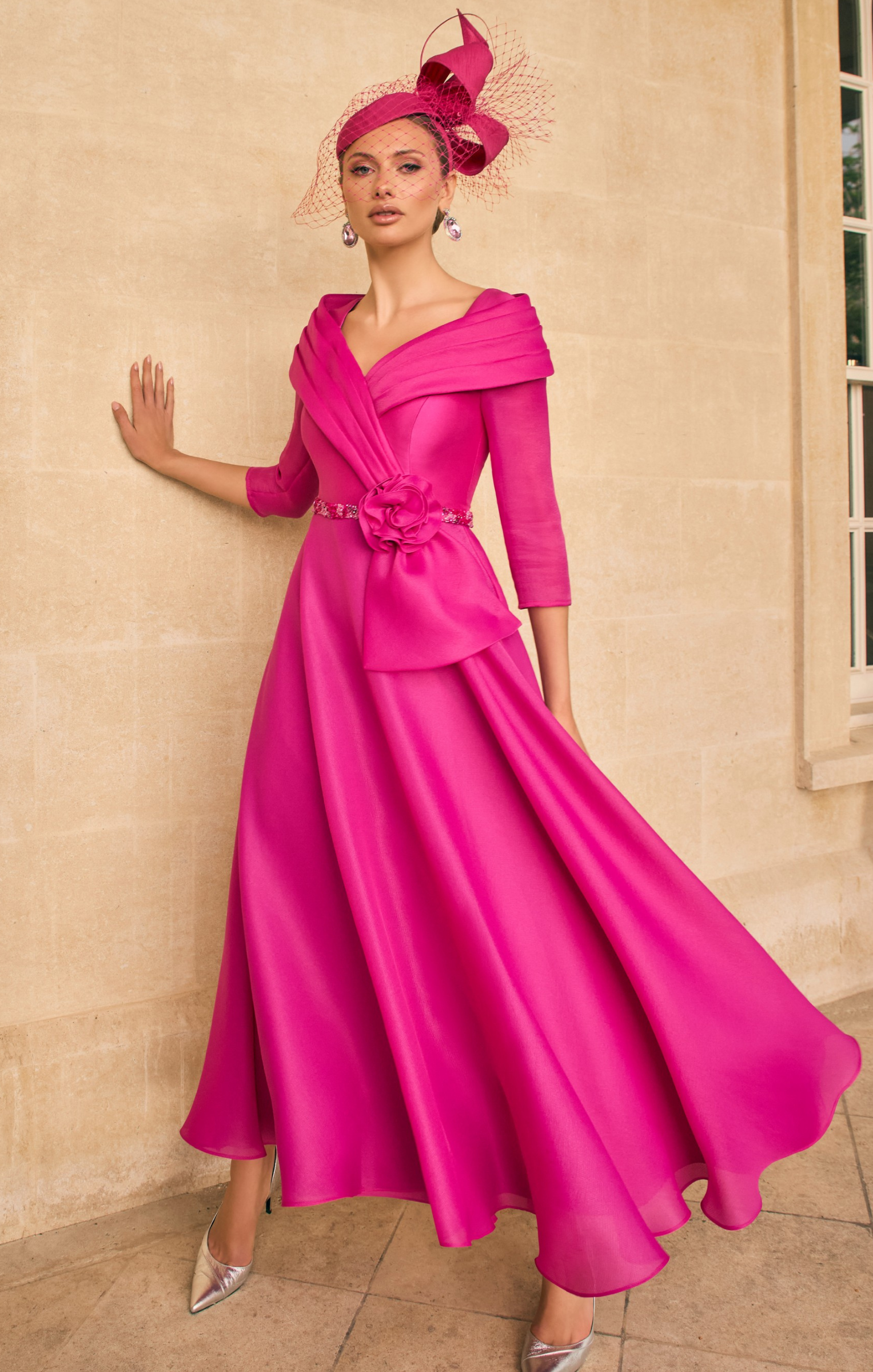 Veni Infantino 992720A Fuchsia Dress with pleated off-the-shoulder collar, beaded trim and A-line flowing skirt. Elegant mikado and organza occasion dress in vibrant fuchsia.