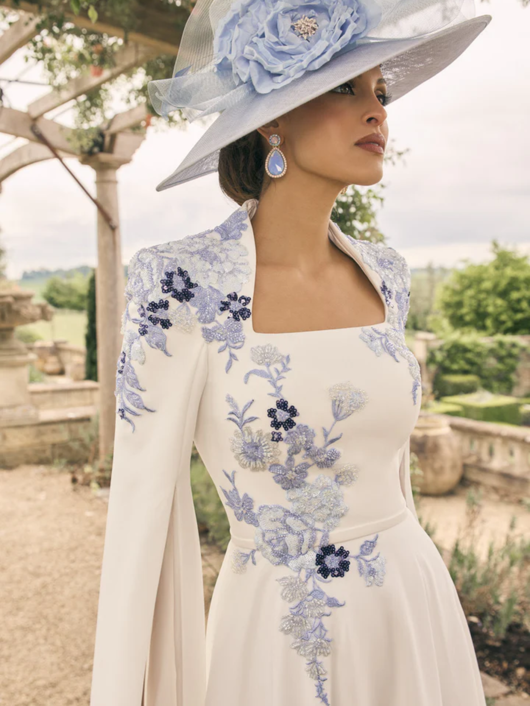 Veni Infantino 992722A Ivory/Pale Blue Dress with cape sleeves, square neckline and beaded lace appliqué details. A-line ivory dress with pale blue embroidery for weddings and special events.
