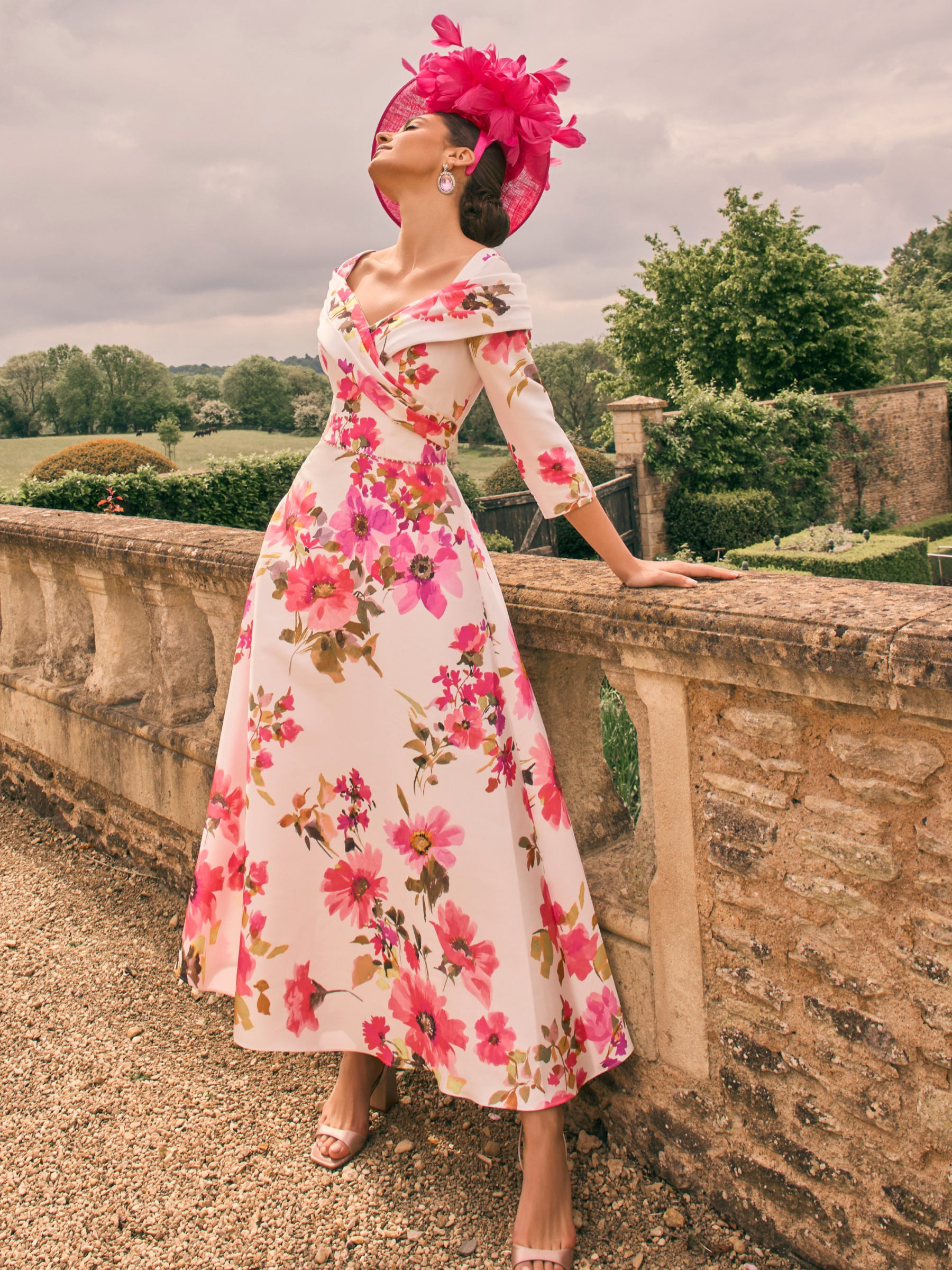 Veni Infantino 992733 Rosa Print Dress in mikado fabric with off-the-shoulder neckline and A-line midi skirt. Elegant floral occasion dress for weddings and special events.