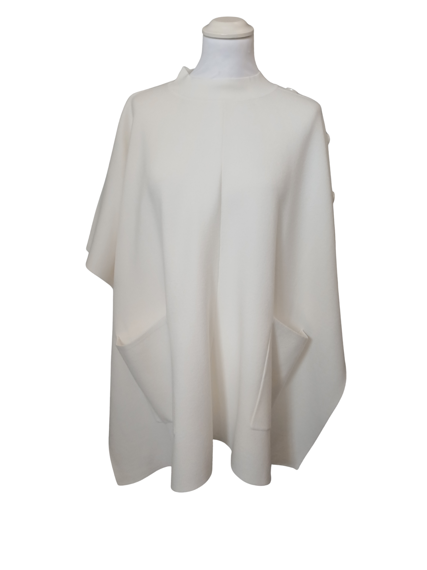 Cape by Alice Collins featuring button detailing on the shoulder, patch pockets and a high neckline – soft lightweight knit ideal for layering and casual everyday wear.