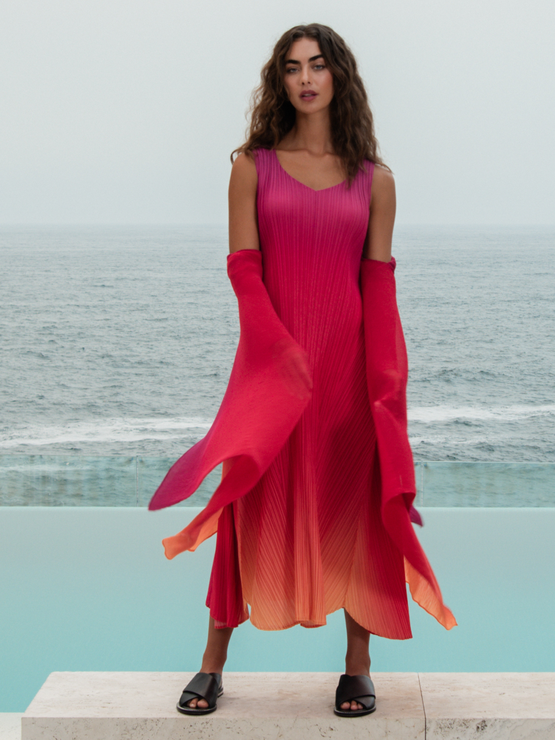 Alquema Festival Sunrise Dress & Coat hand-pleated dress and coat set with pink and coral ombré, flowing silhouette and draped sleeves.