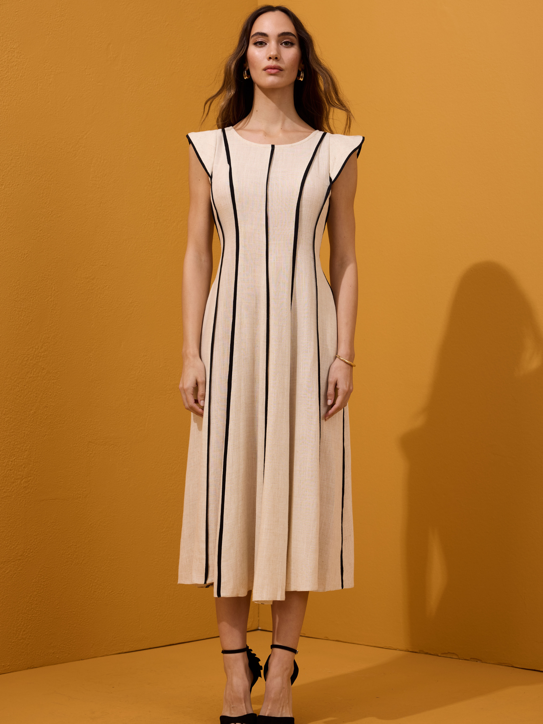 Arggido 49540 midi dress with structured panel detailing, cap sleeves and softly flared skirt.