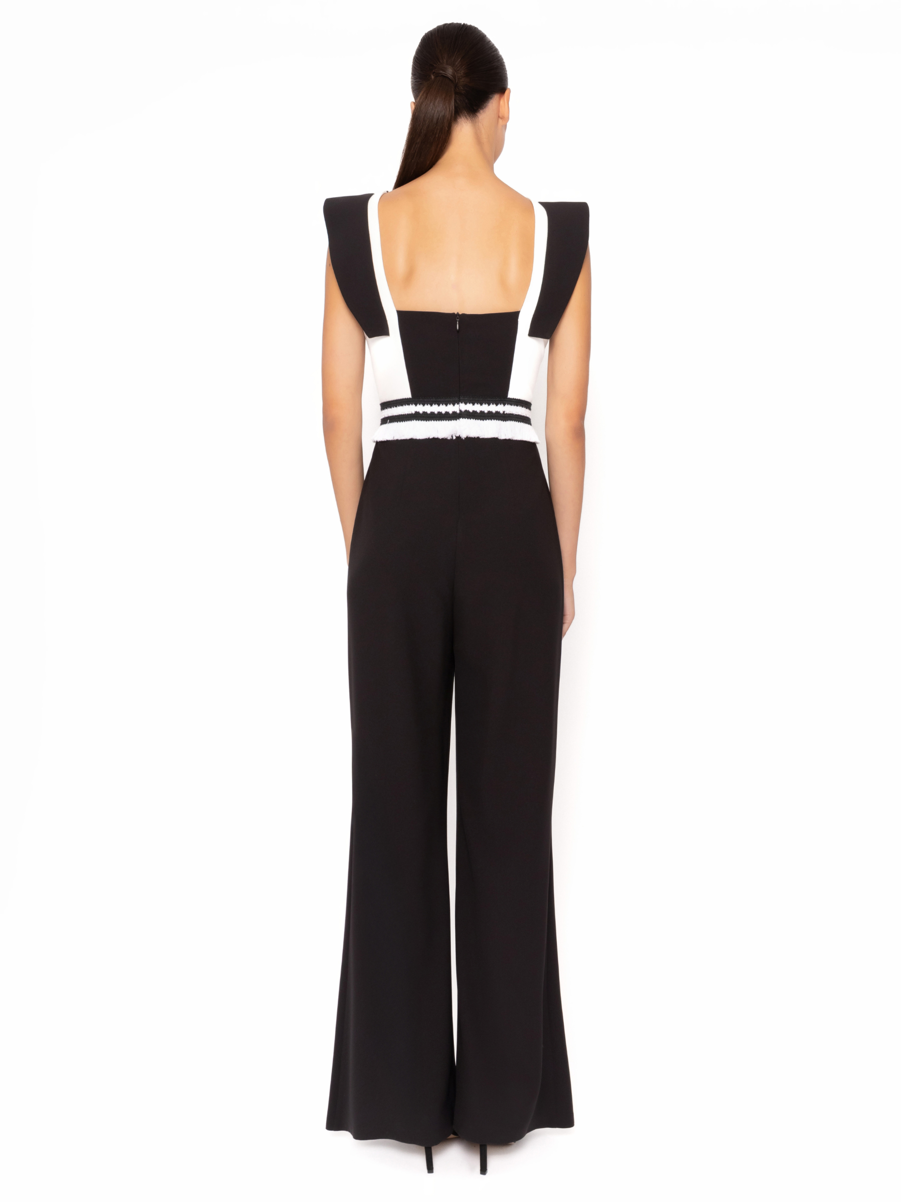 Arggido 49583 fringe jumpsuit with structured shoulders, fringe waist detail and wide leg trousers.