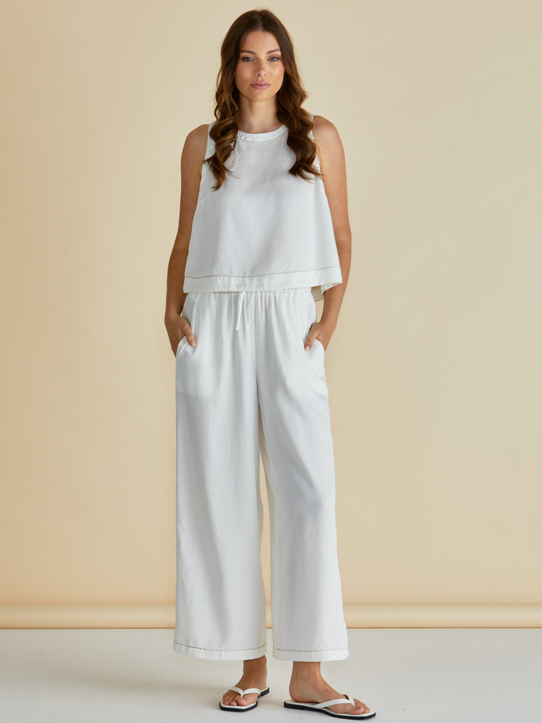 Betty Copacabana Shell Top with sleeveless silhouette, round neckline and button-back fastening.