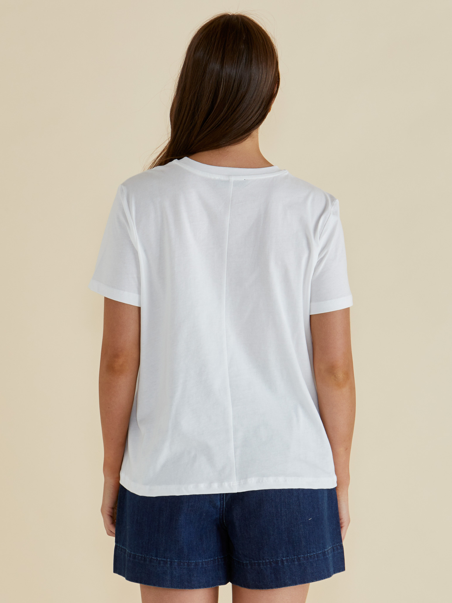 Betty Ellia Crew Tee with crew neckline, short sleeves and statement front graphic design available in tropical “Paradise” print or pink striped fish motif.