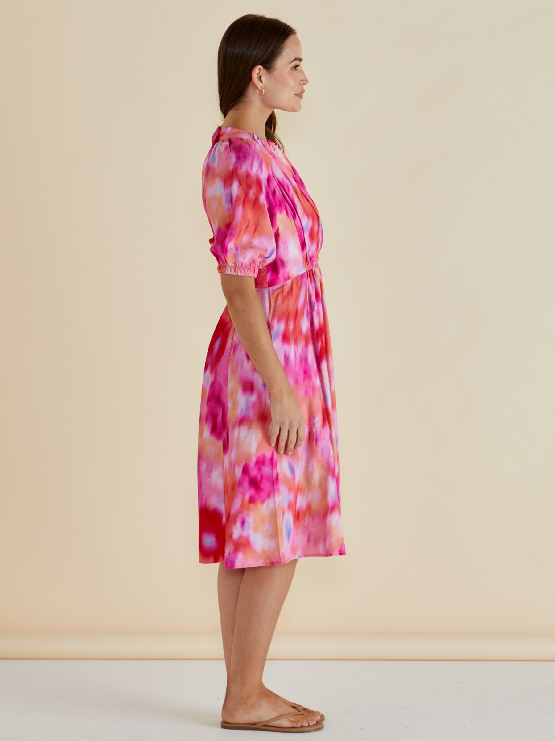 Betty Emery Dress with V-notch neckline, short puff sleeves, elasticated waist and midi-length A-line skirt.