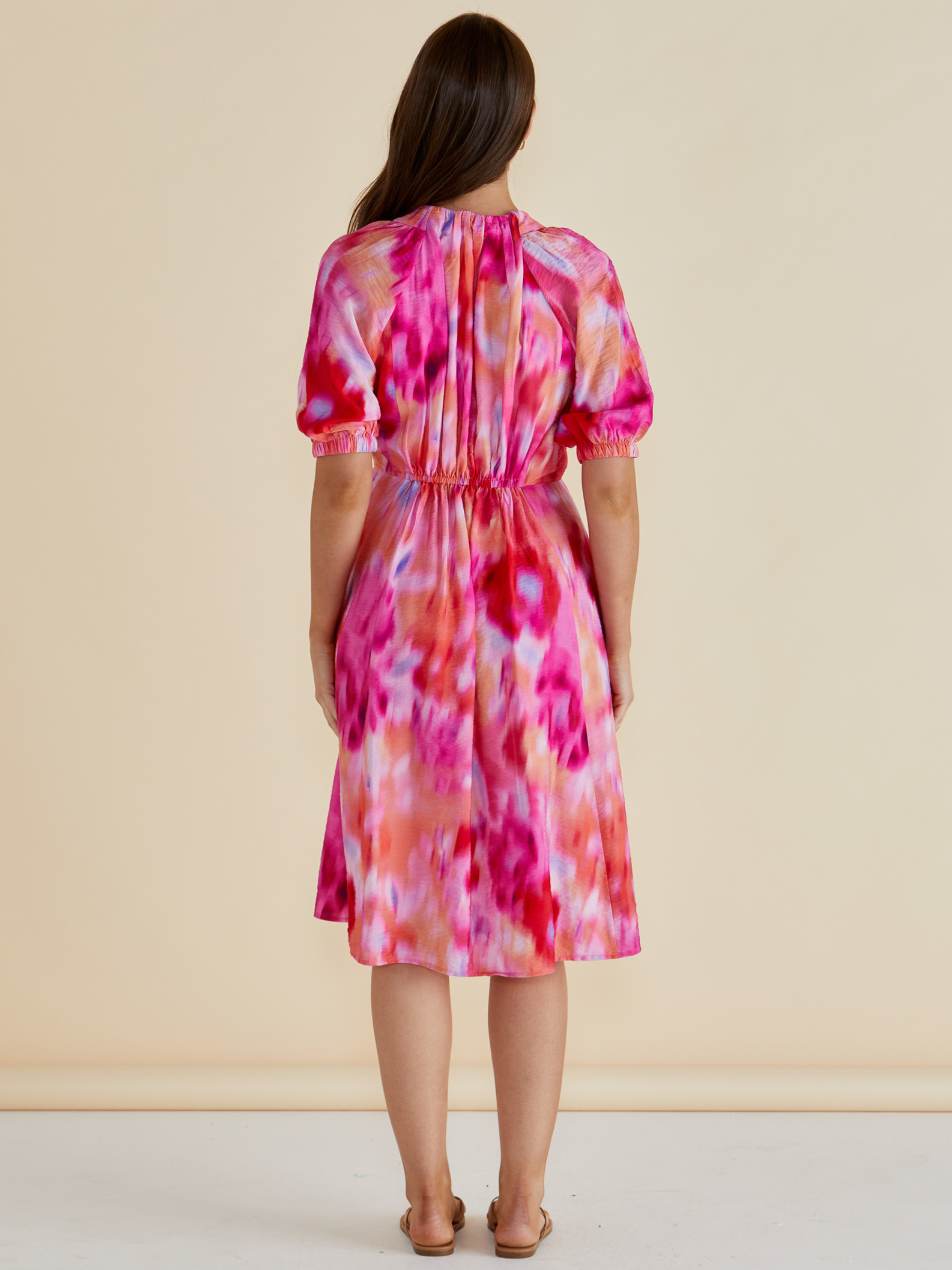 Betty Emery Dress with V-notch neckline, short puff sleeves, elasticated waist and midi-length A-line skirt.