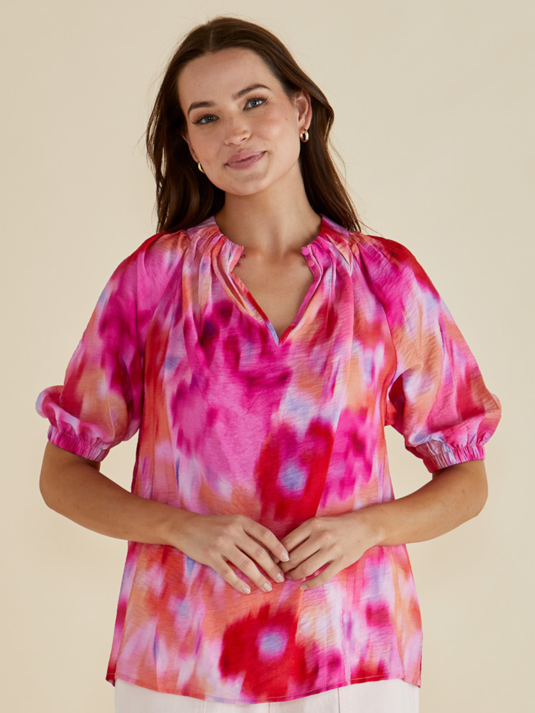 Betty Joanne Blouse with V-notch neckline, short puff sleeves and abstract floral print.