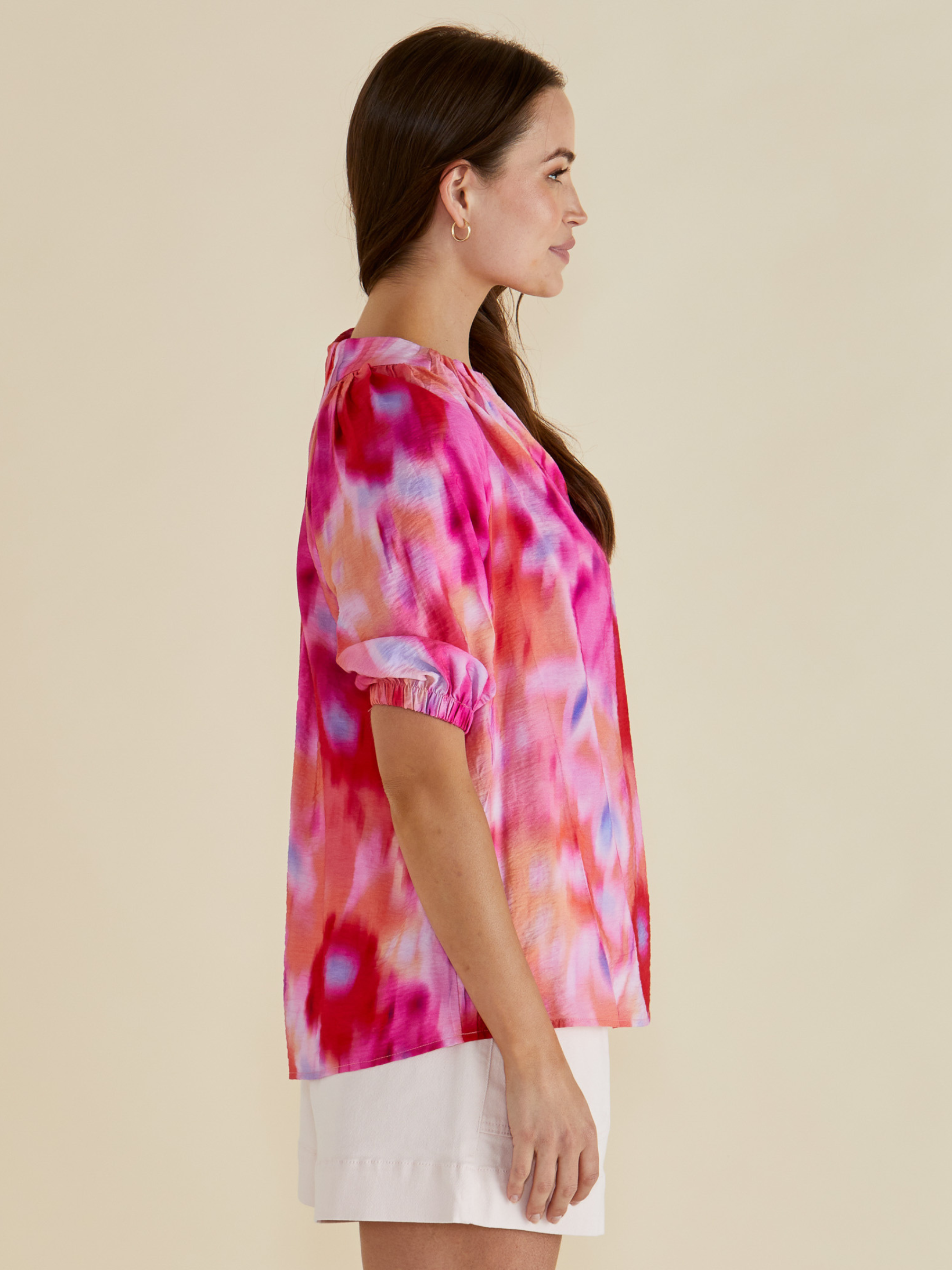 Betty Joanne Blouse with V-notch neckline, short puff sleeves and abstract floral print.