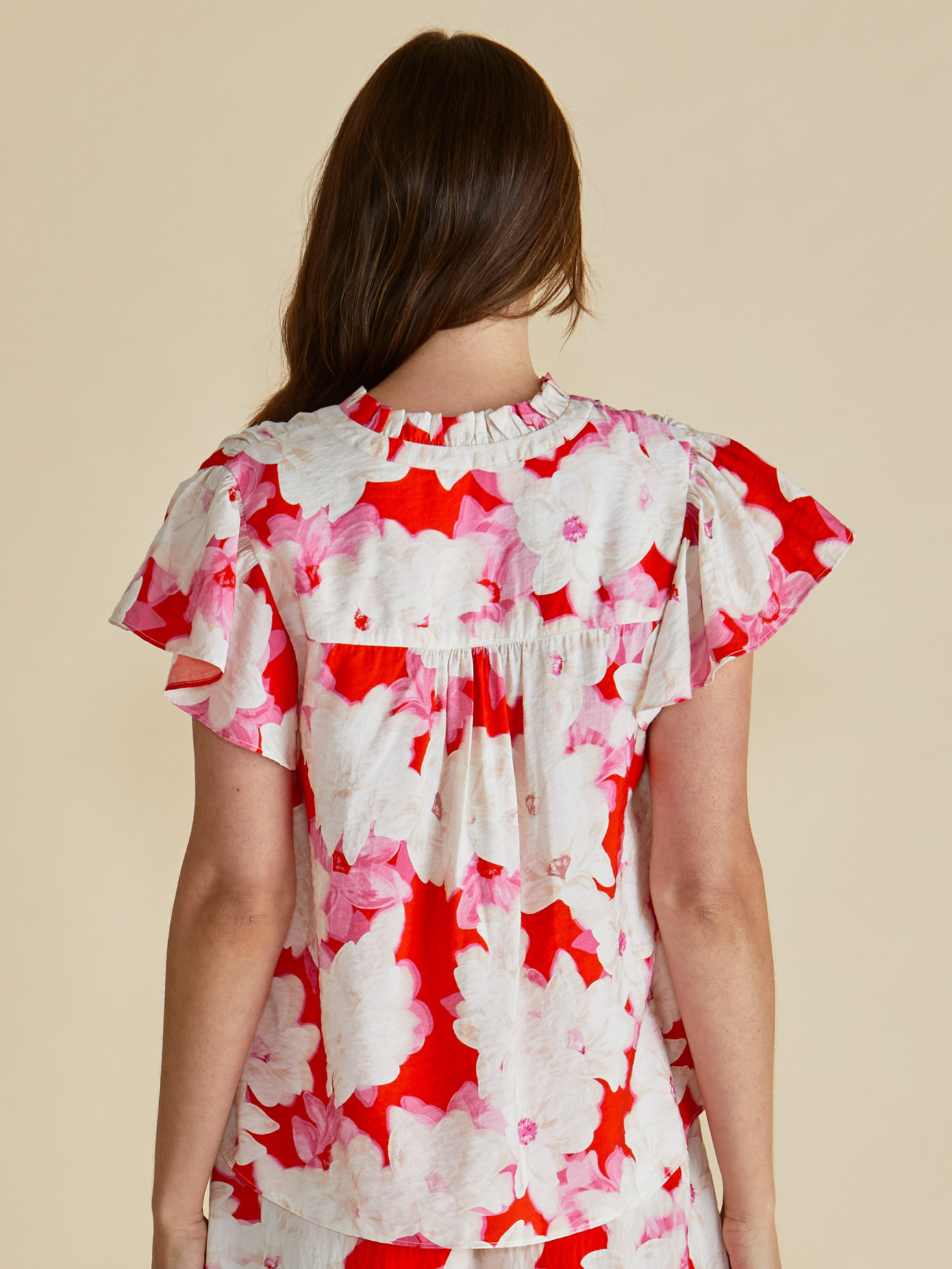 Betty Lyra Blouse with V neckline, tie detail and short flutter sleeves.
