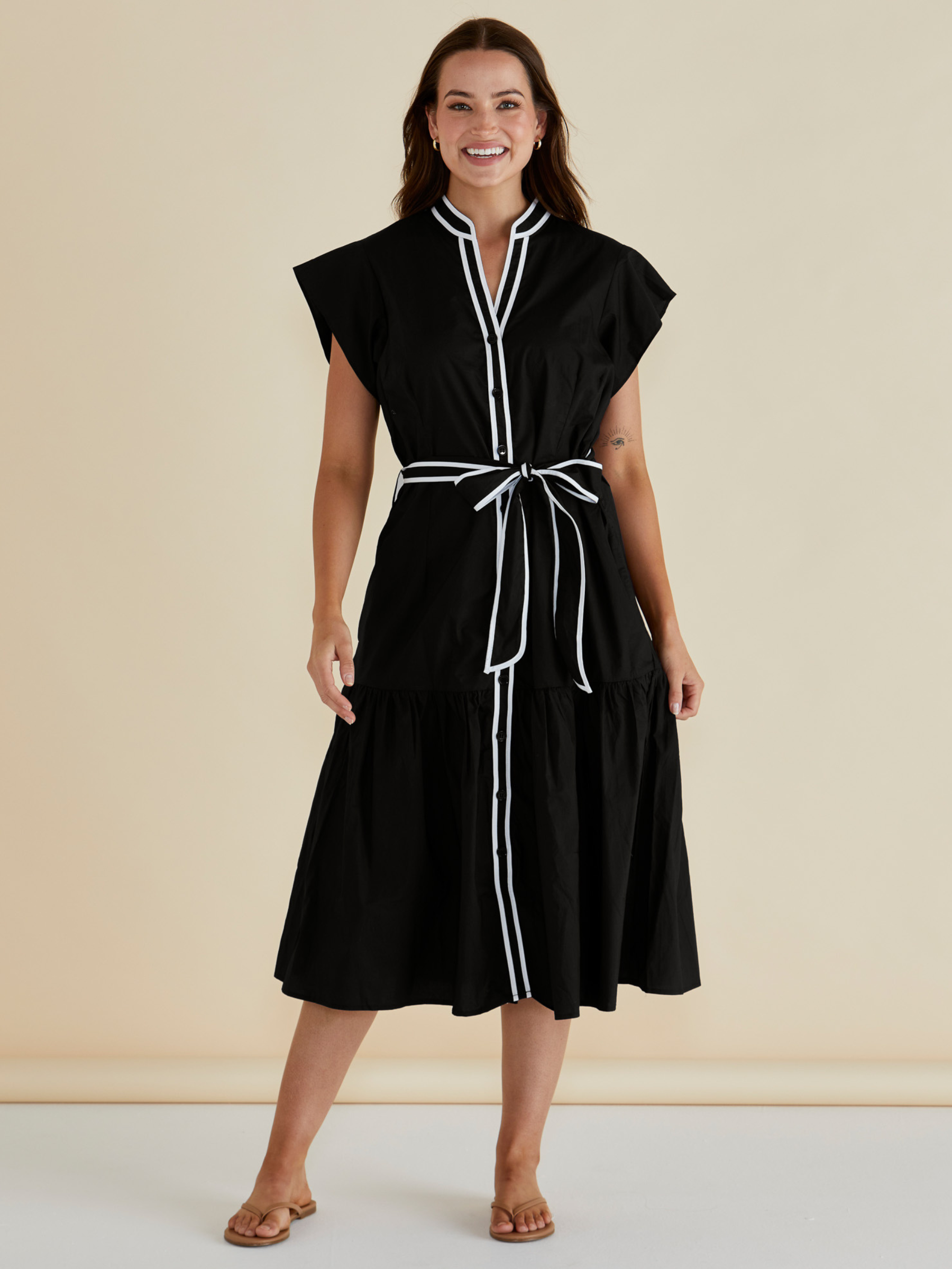 Betty Mari Dress with contrast trim neckline, button-through front, self-tie waist belt and tiered midi skirt.