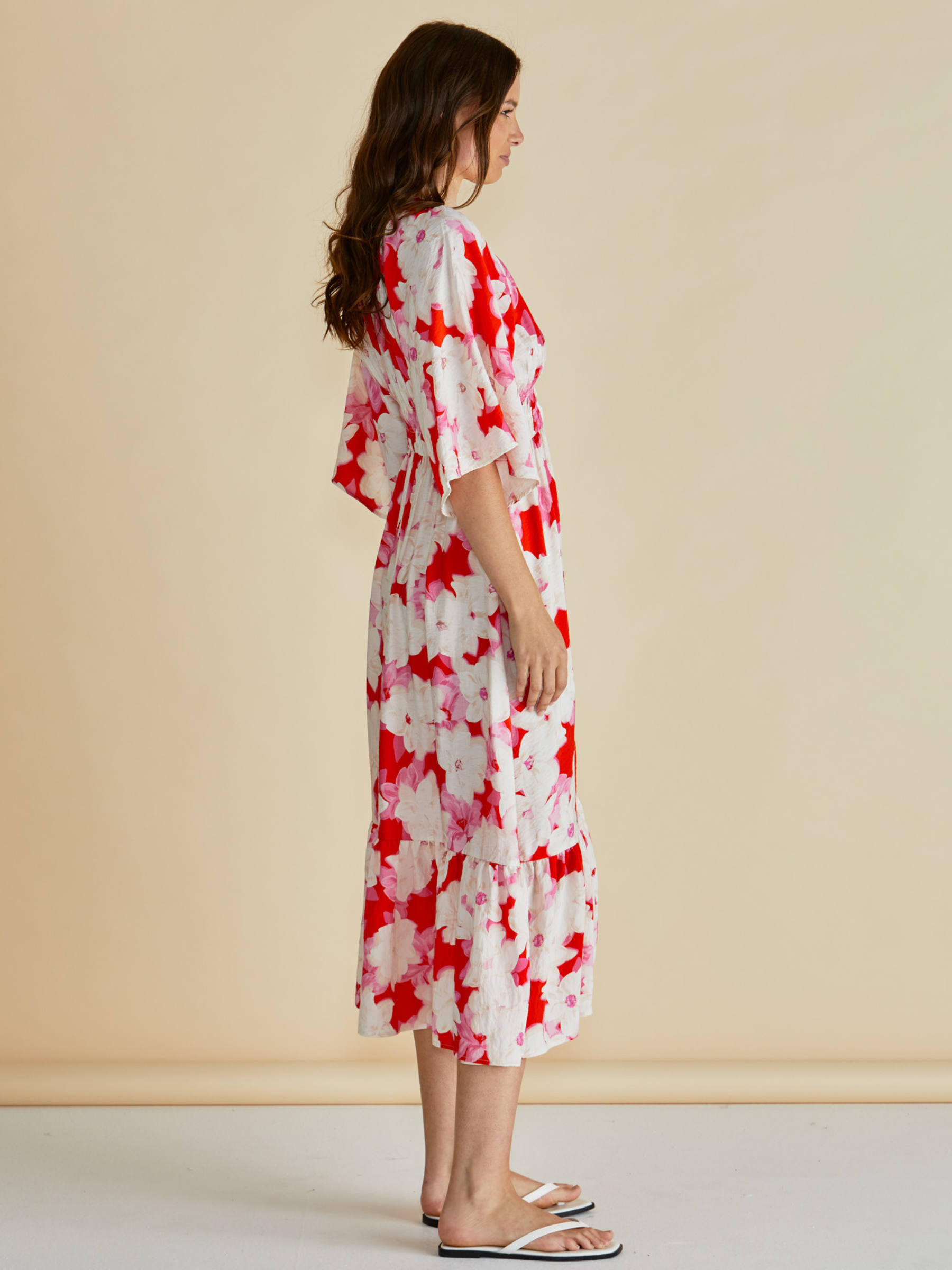 Betty Moxie Dress with V neckline, button-through front, flutter sleeves, elasticated waist and tiered skirt.