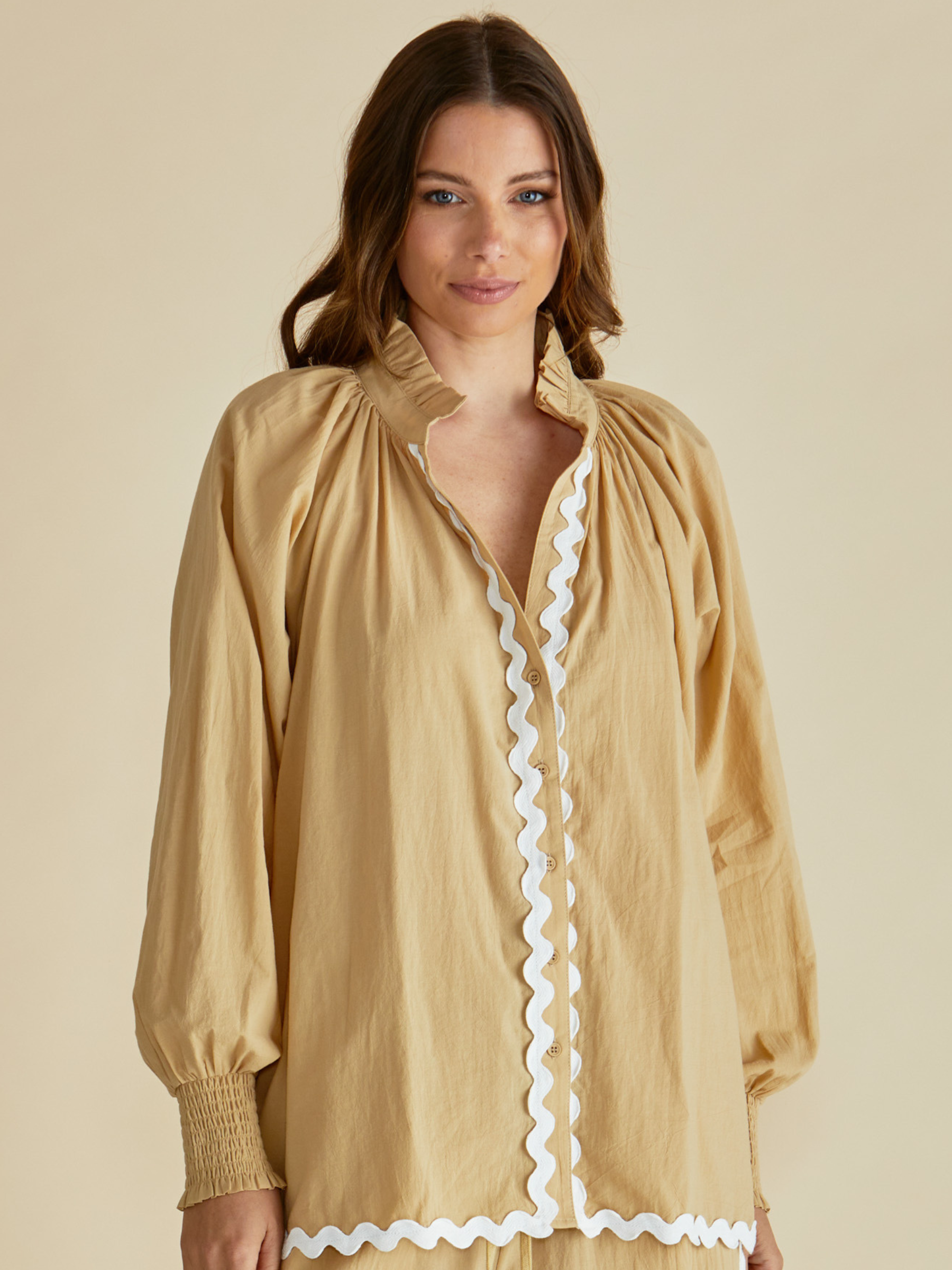 Betty Romi Shirt with frill collar, button-through front, long sleeves and smocked cuffs.