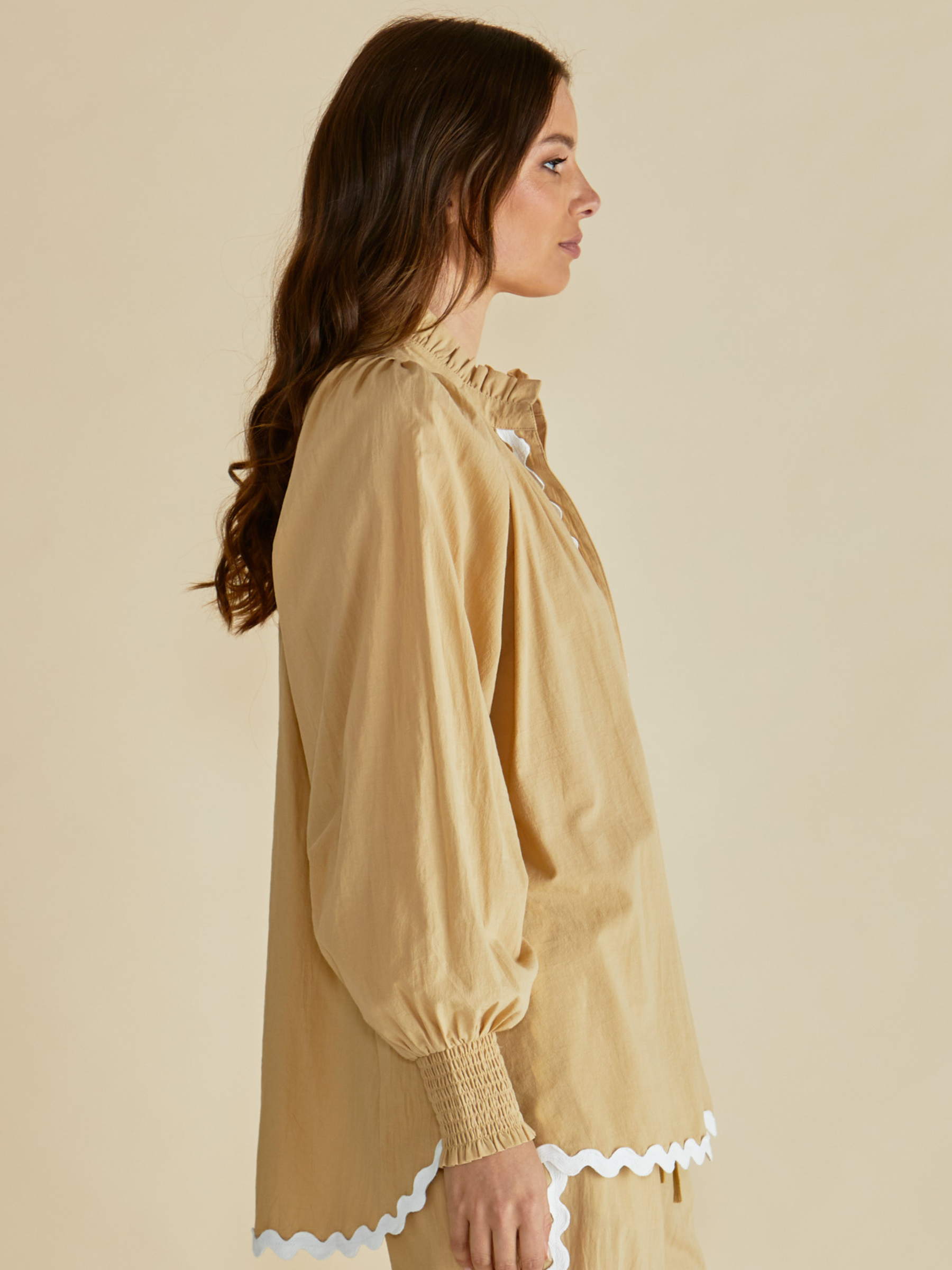 Betty Romi Shirt with frill collar, button-through front, long sleeves and smocked cuffs.