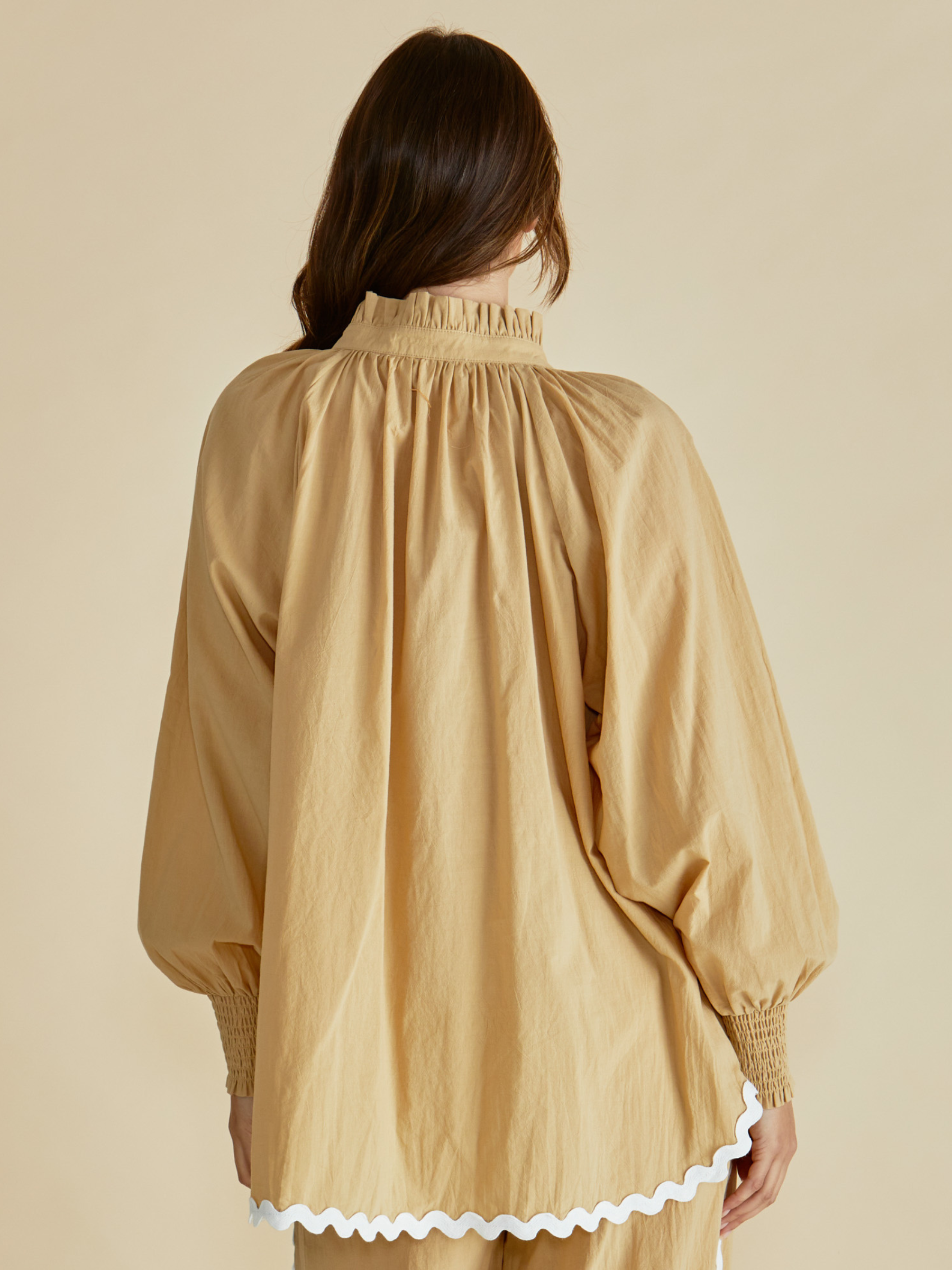 Betty Romi Shirt with frill collar, button-through front, long sleeves and smocked cuffs.