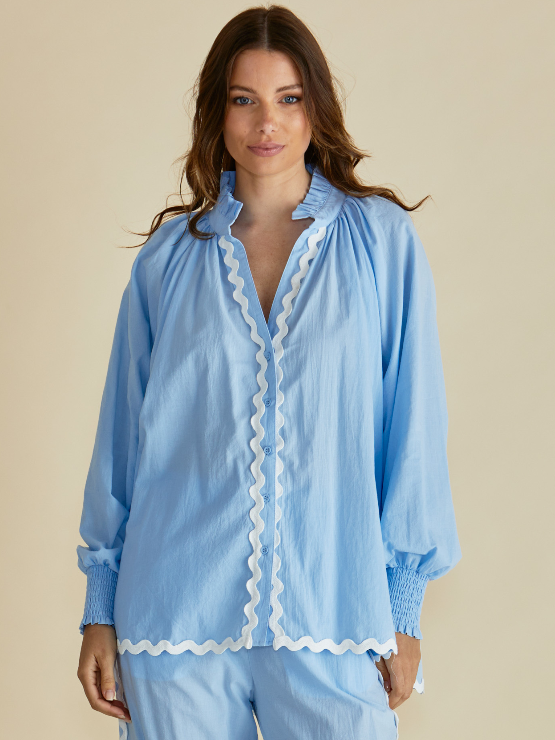 Betty Romi Shirt with frill collar, button-through front, long sleeves and smocked cuffs.