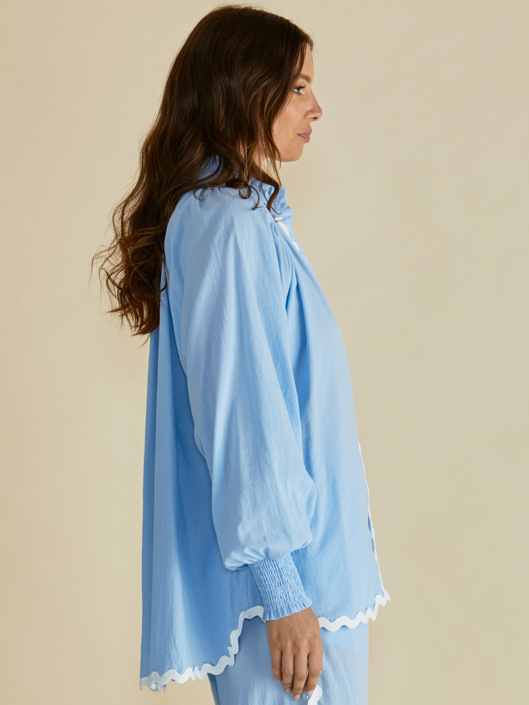 Betty Romi Shirt with frill collar, button-through front, long sleeves and smocked cuffs.