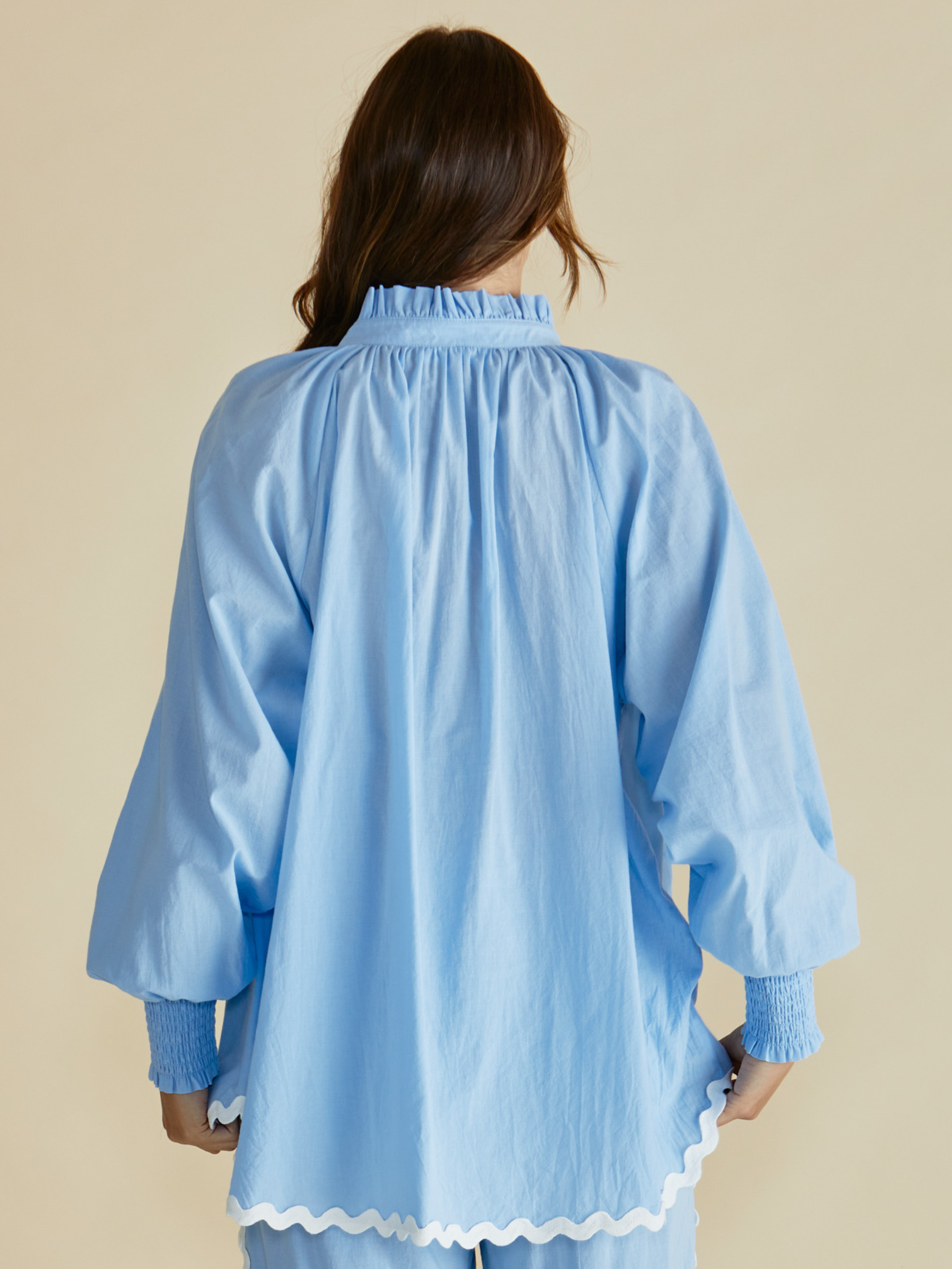 Betty Romi Shirt with frill collar, button-through front, long sleeves and smocked cuffs.