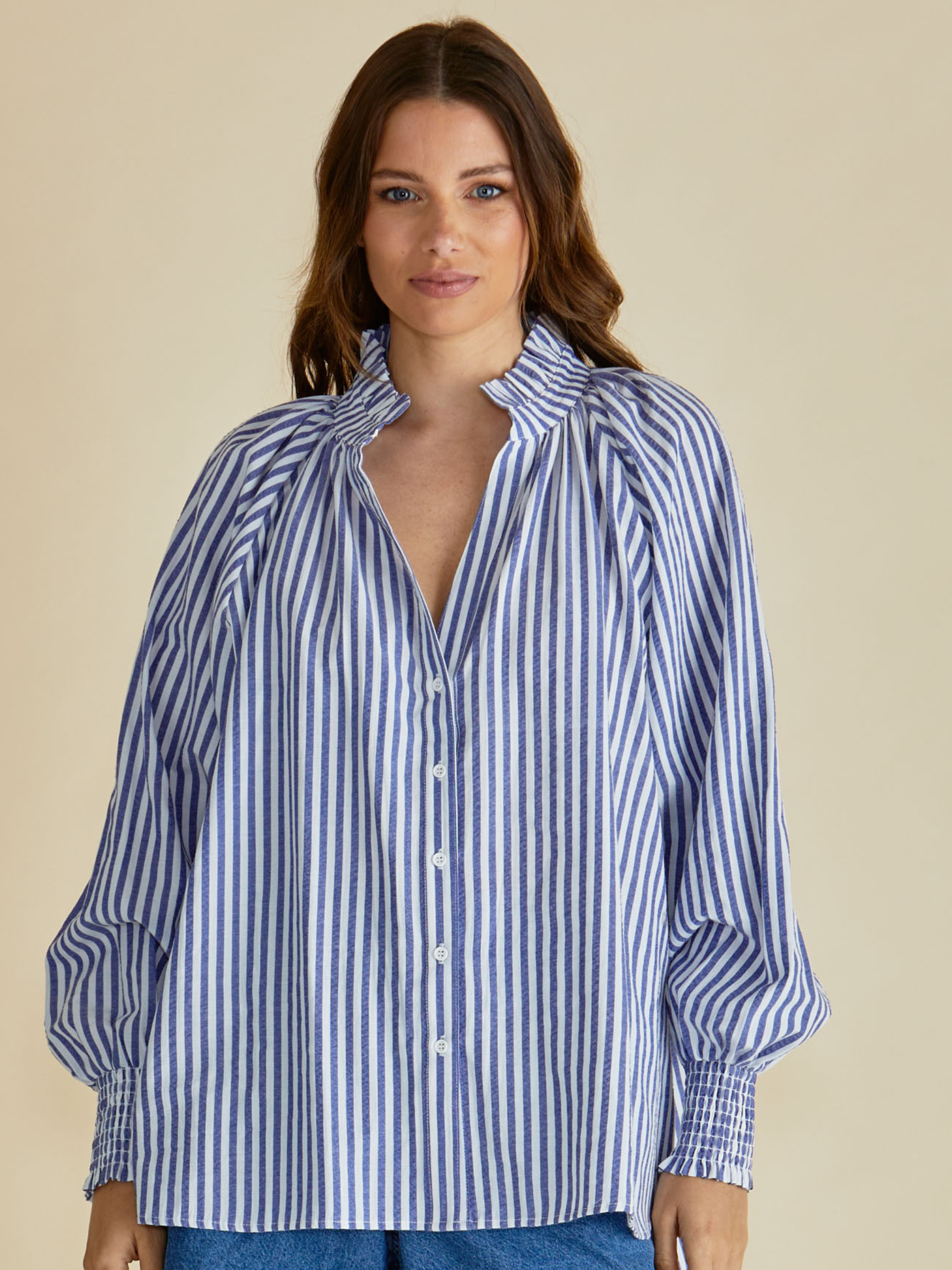 Betty Romi Shirt with frill collar, button-through front, long sleeves and smocked cuffs.