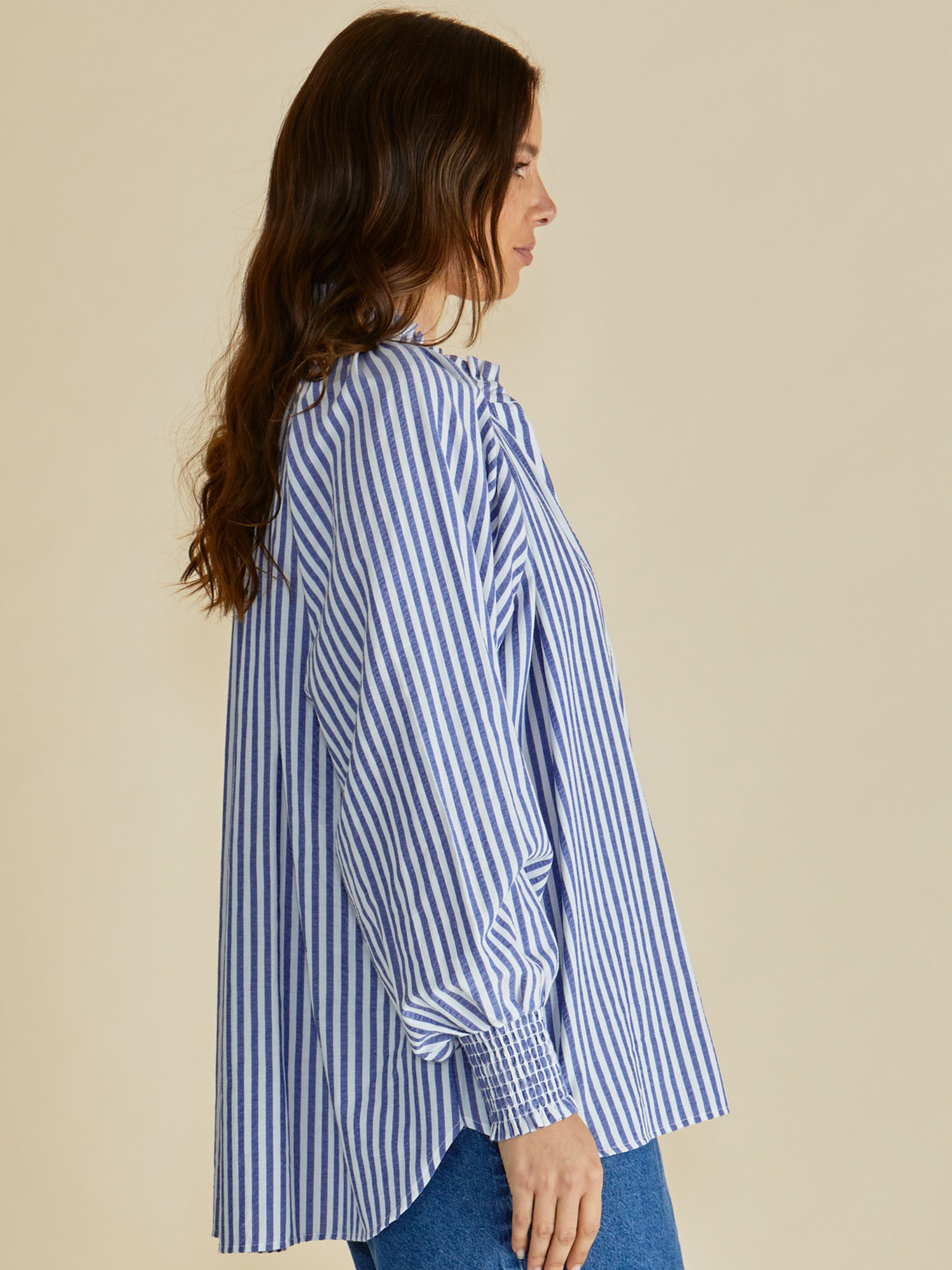 Betty Romi Shirt with frill collar, button-through front, long sleeves and smocked cuffs.