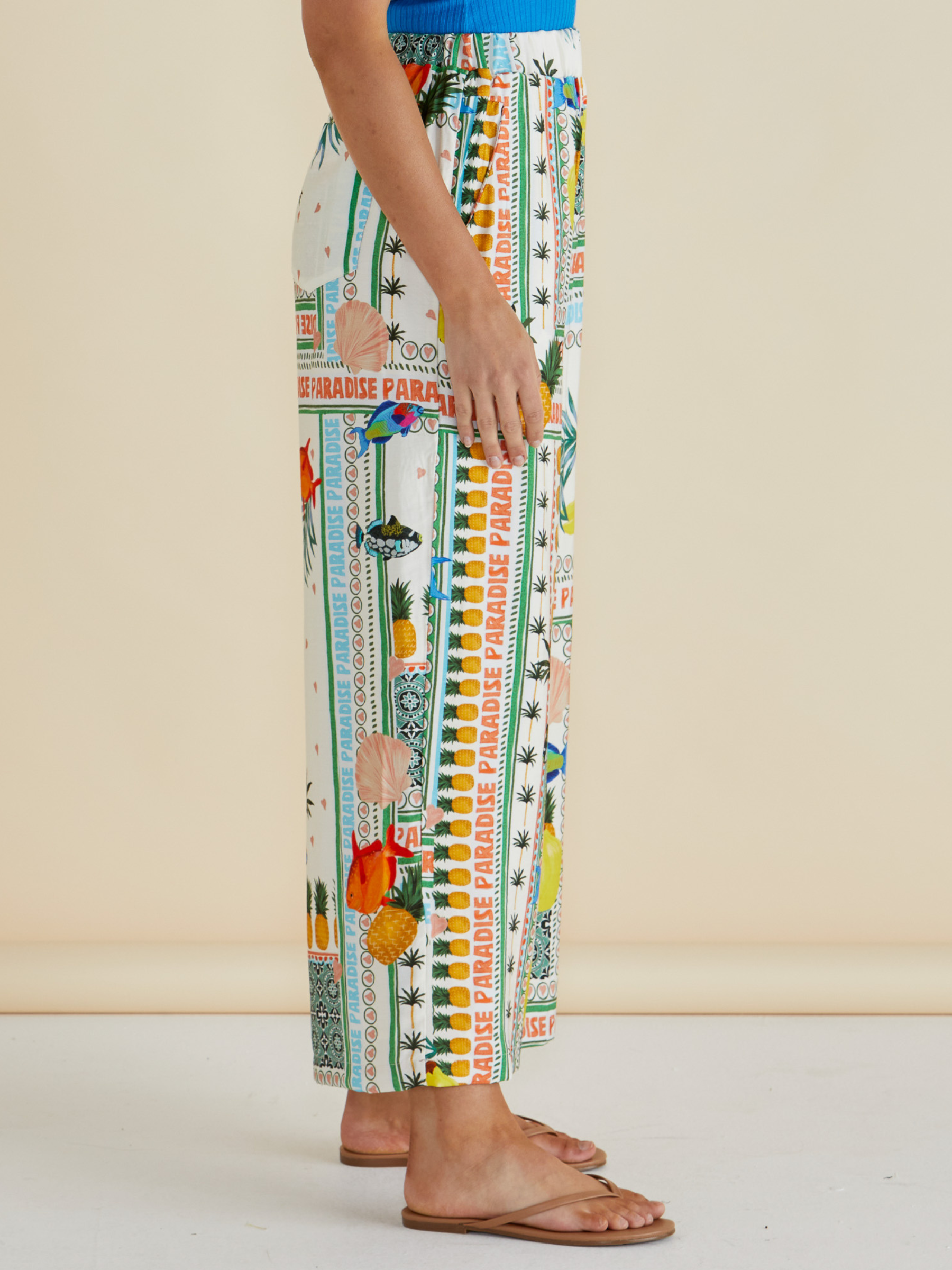 Betty Sable Wide Leg Pant with elasticated waistband, wide-leg silhouette and colourful tropical “Paradise” patchwork print.