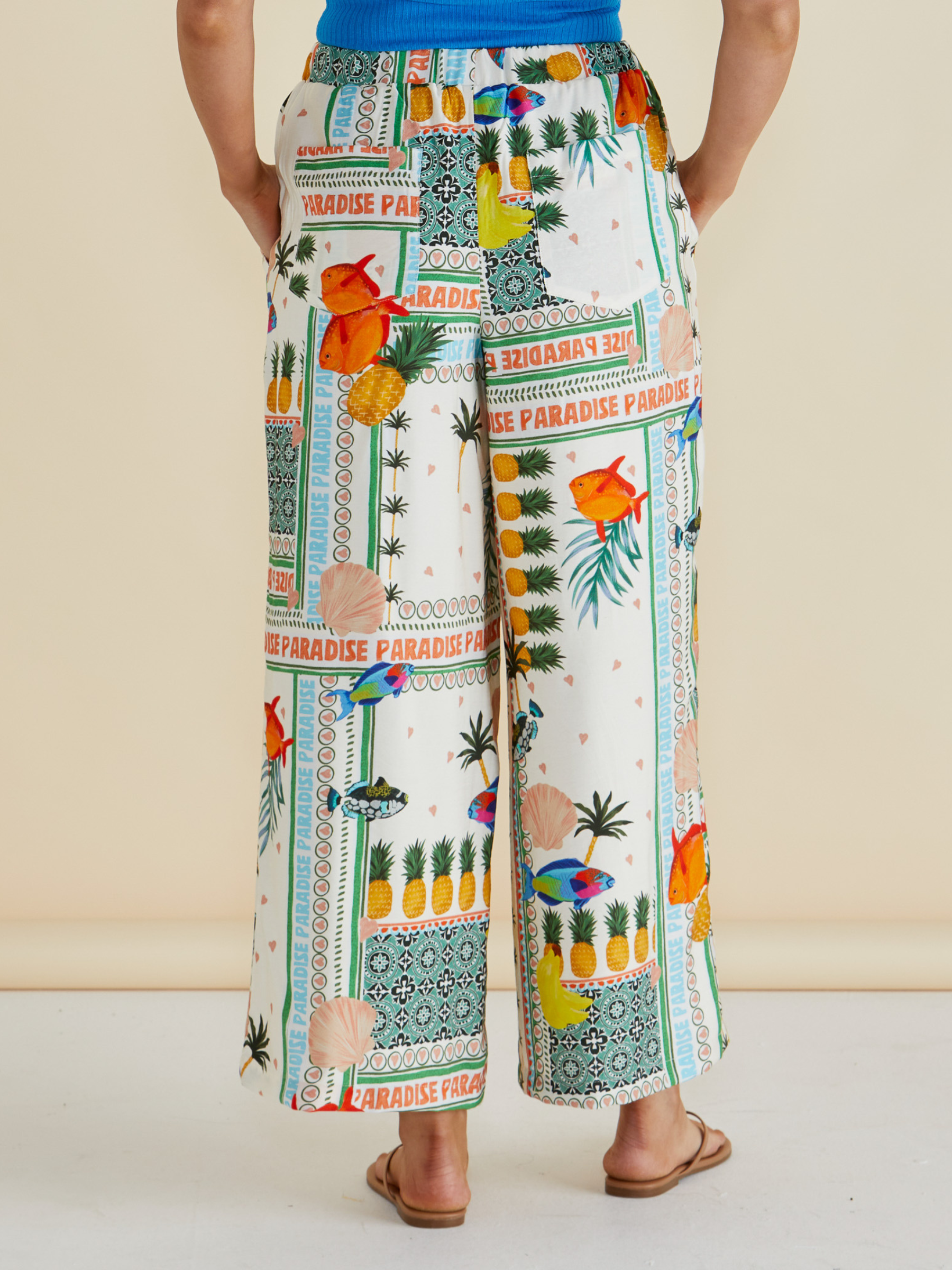 Betty Sable Wide Leg Pant with elasticated waistband, wide-leg silhouette and colourful tropical “Paradise” patchwork print.