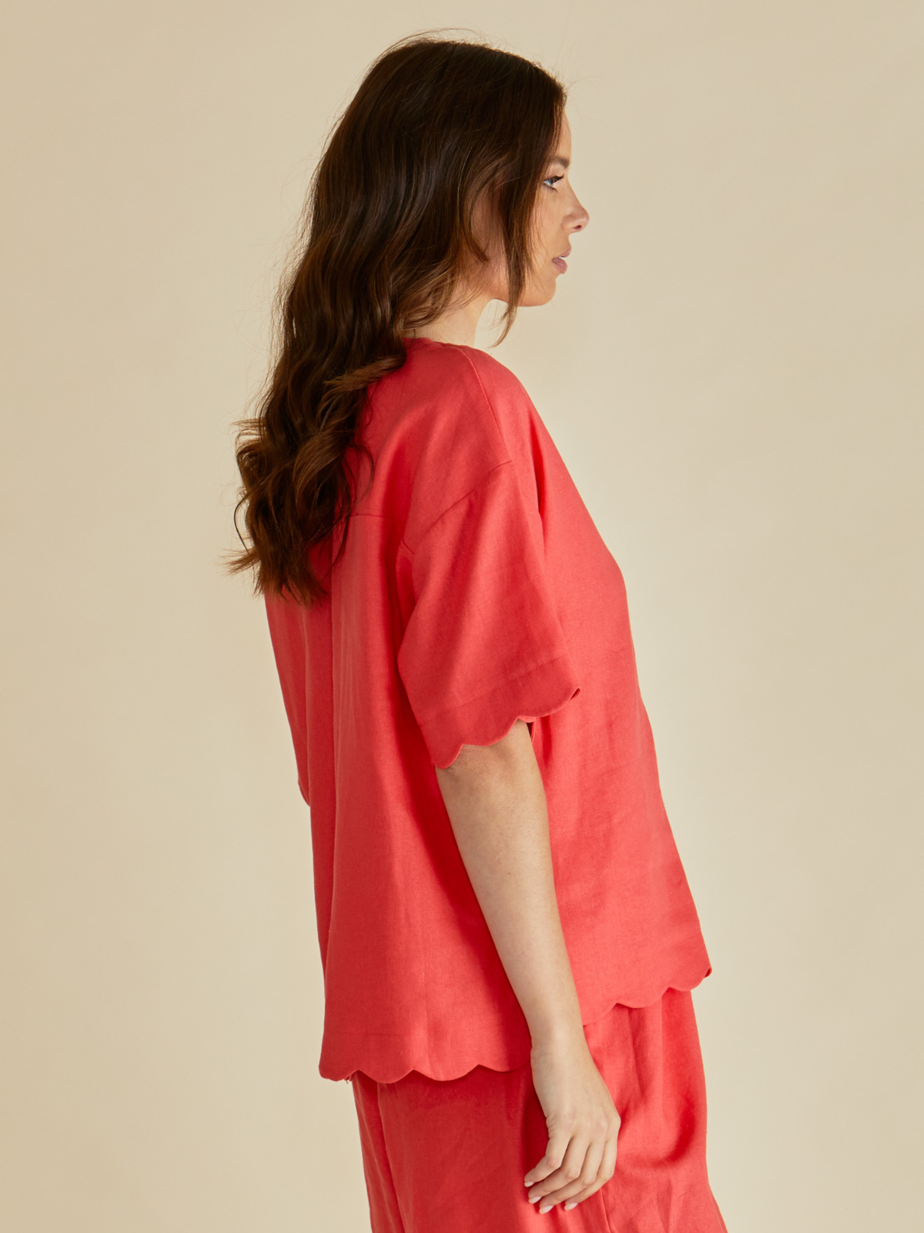 Betty Scarlett Shirt with V neckline, button-through front, short sleeves and scalloped hem.