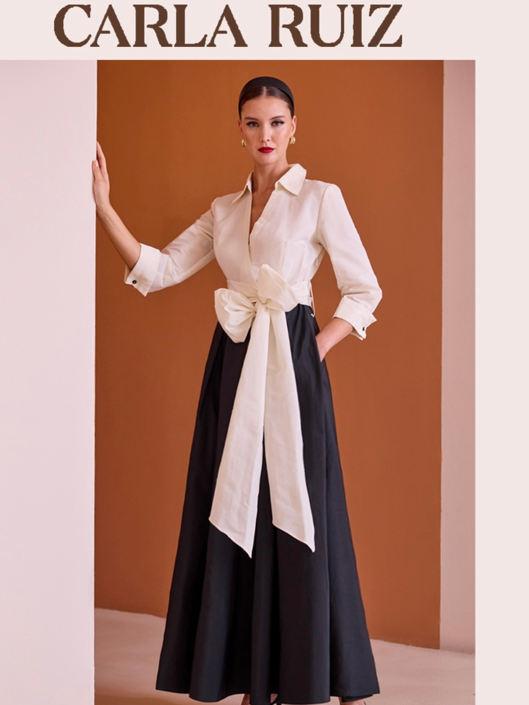 Carla Ruiz 152502 white and black dress with plunging V-neck bodice, tie waist sash and flowing A-line maxi skirt.