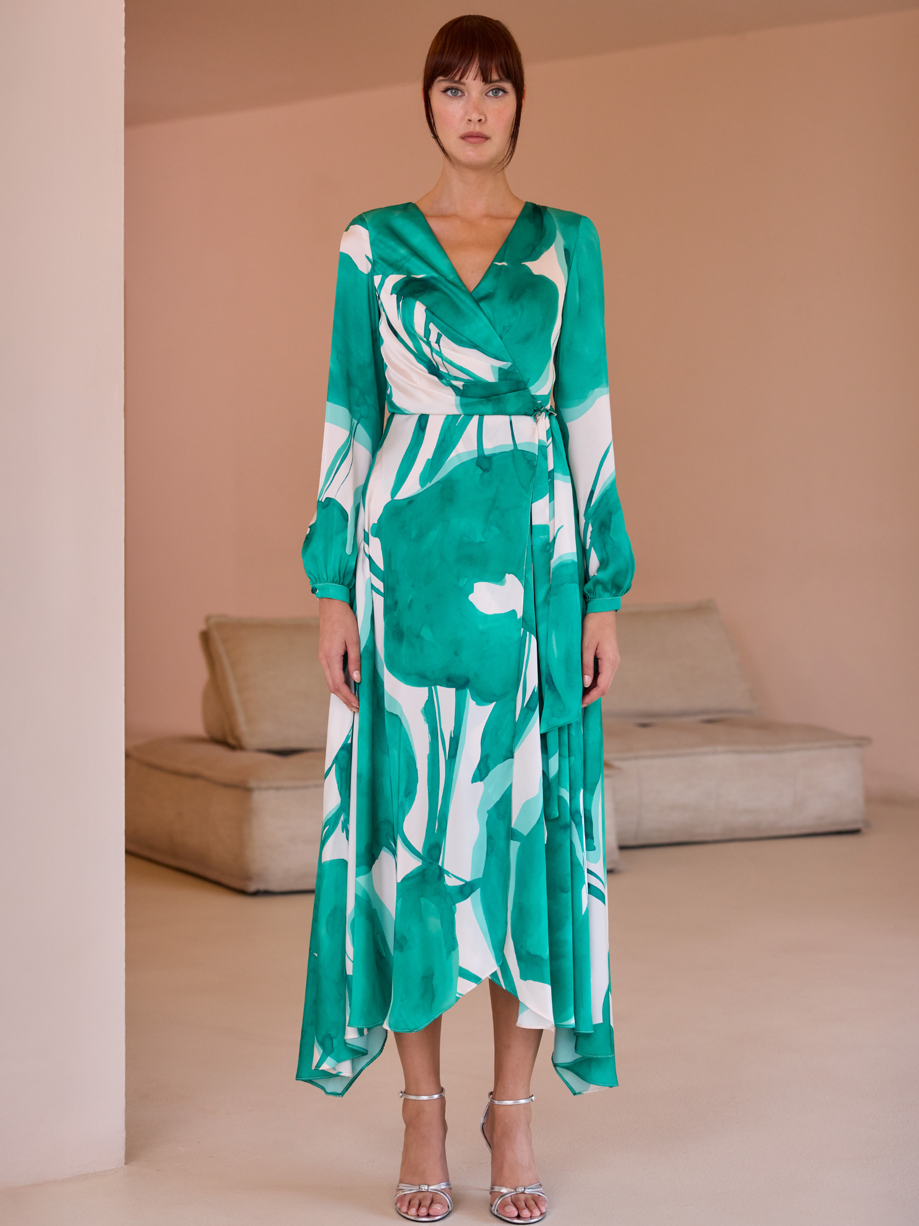 Carla Ruiz 52569 Green Dress with wrap bodice, long sleeves, abstract print and asymmetrical handkerchief-hem A-line skirt.