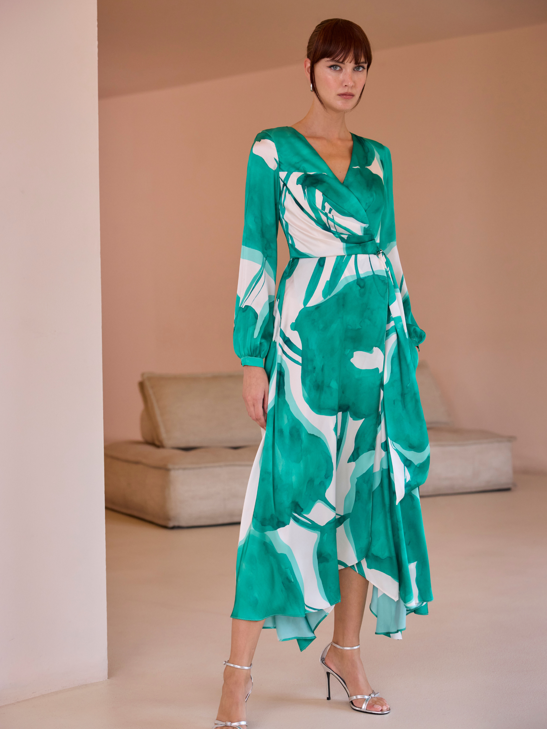 Carla Ruiz 52569 Green Dress with wrap bodice, long sleeves, abstract print and asymmetrical handkerchief-hem A-line skirt.