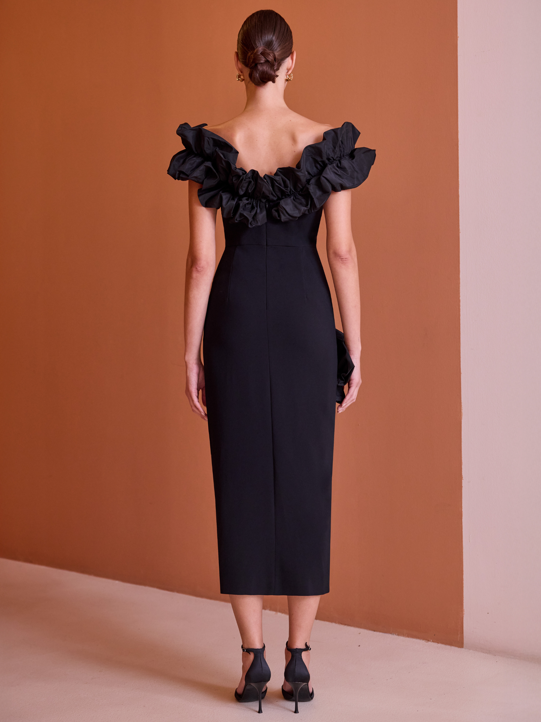 Carla Ruiz 52606 black fitted dress with off-the-shoulder neckline, ruffle detailing and front split.