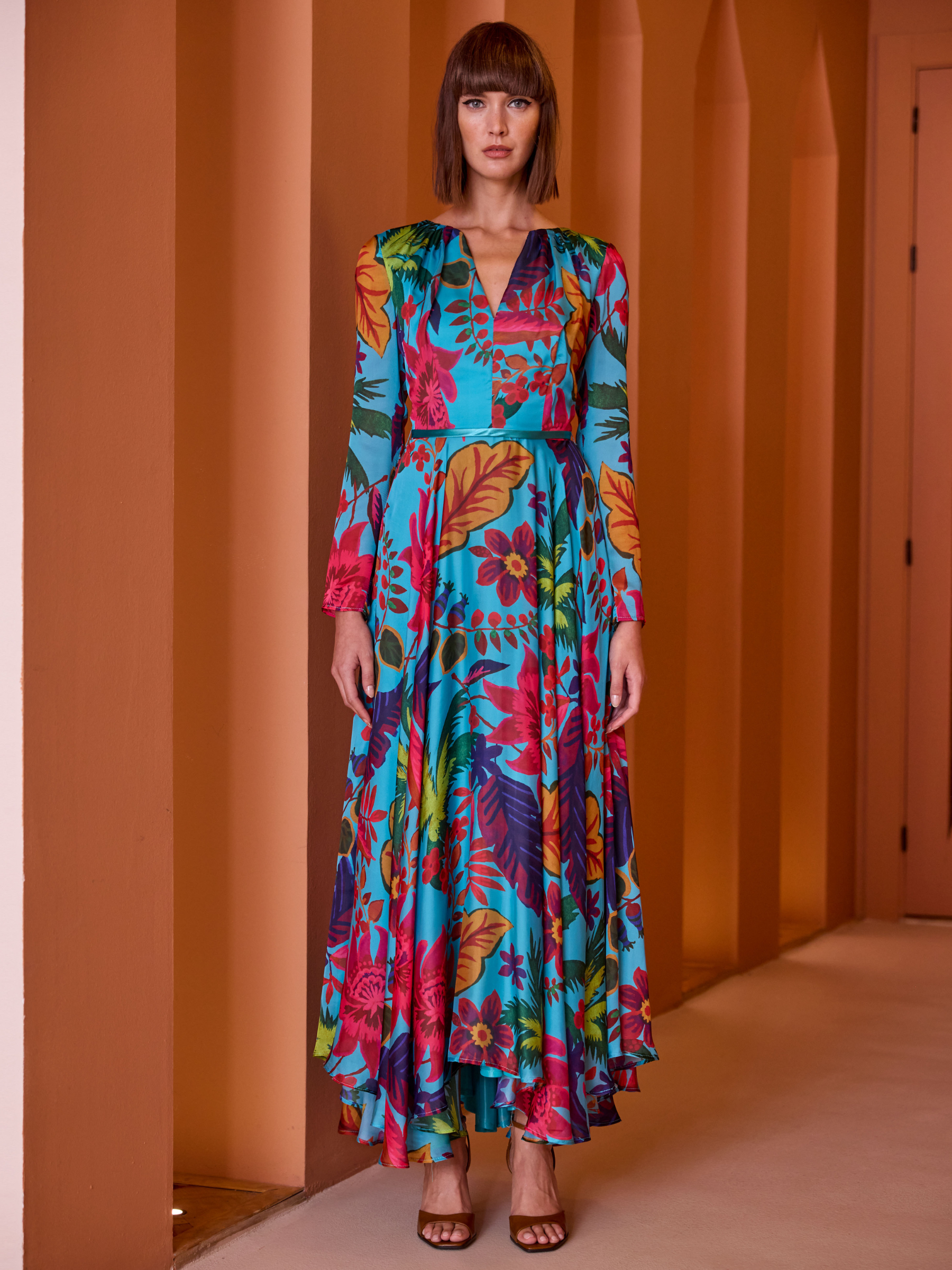 Carla Ruiz 52649 Turquoise Dress with tropical print, V-neckline, long sleeves and flowing asymmetric maxi skirt.
