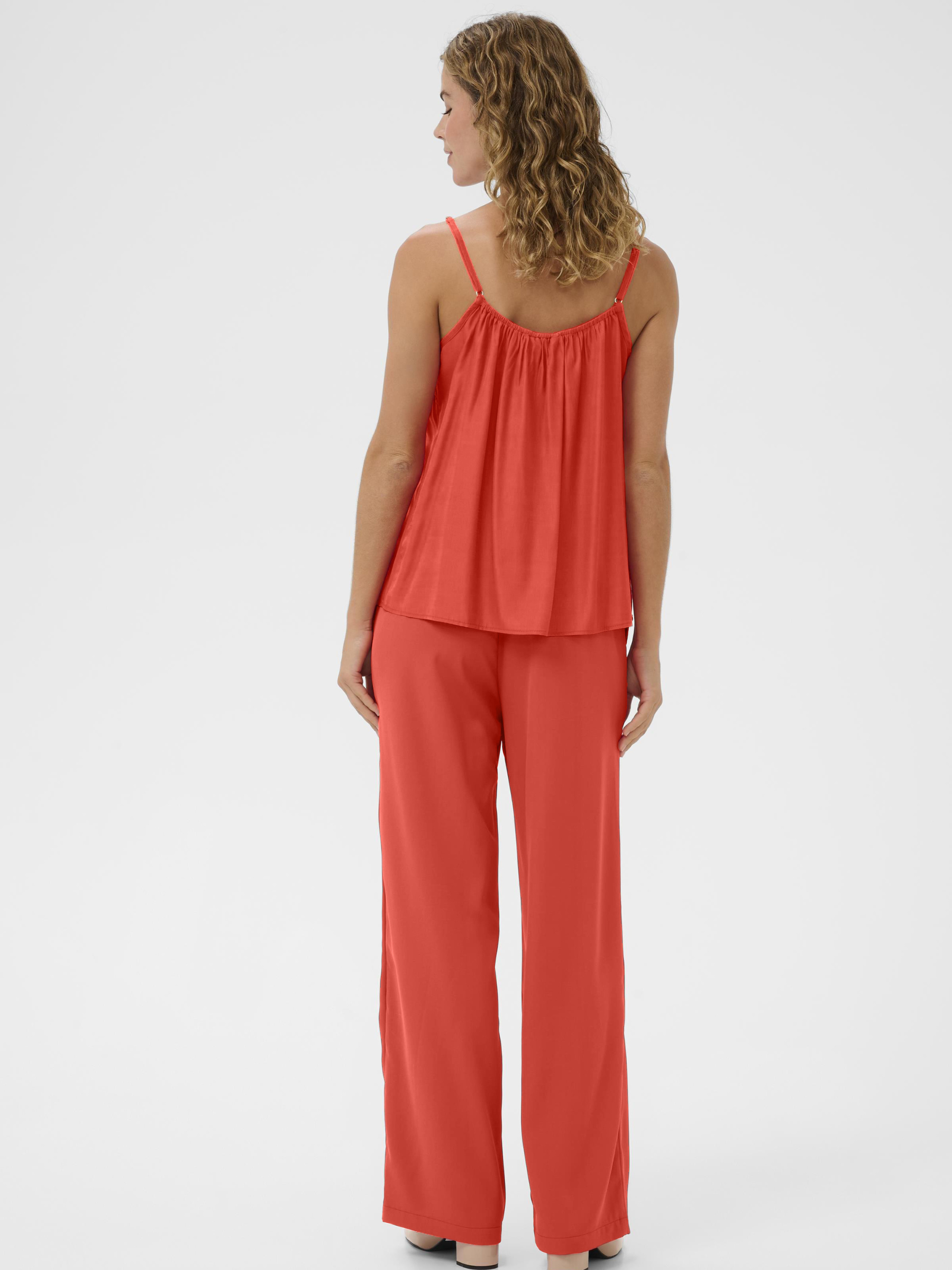 Cream Anna women’s A-line camisole top with lace neckline detail, adjustable straps and hip-length fit, styled with jeans.