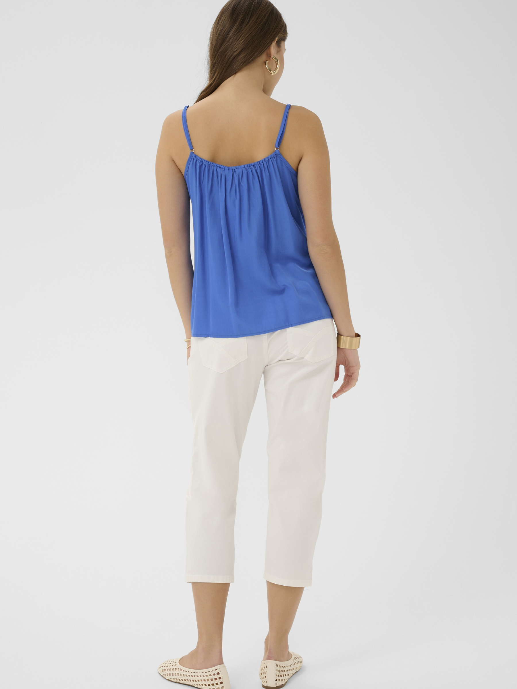 Cream Anna women’s A-line camisole top with lace neckline detail, adjustable straps and hip-length fit, styled with jeans.