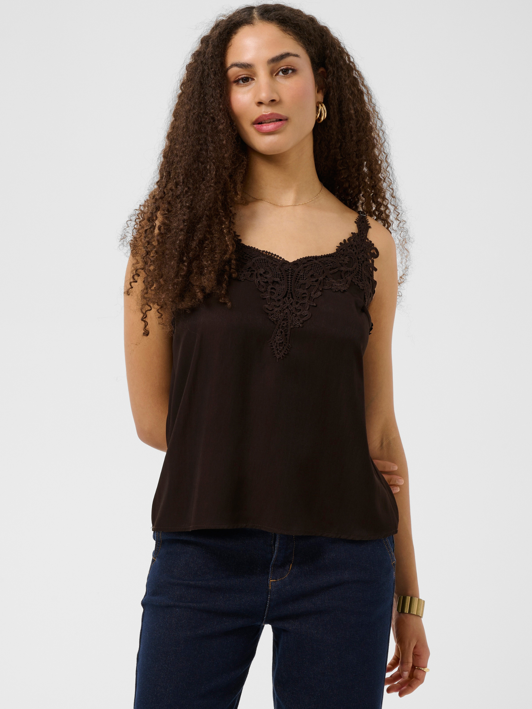 Cream Anna women’s A-line camisole top with lace neckline detail, adjustable straps and hip-length fit, styled with jeans.